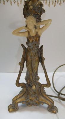 Ornate brass and resin table lamp depicting a flapper