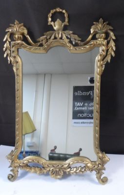 An ornate gilt framed mirror