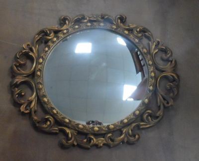 Ornately framed, circular mirror