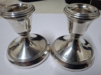 Pair of dwarf Birmingham hallmarked silver candlesticks with weighted bases