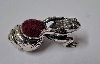 Small pin cushion in the form of a Frog pulling a shell