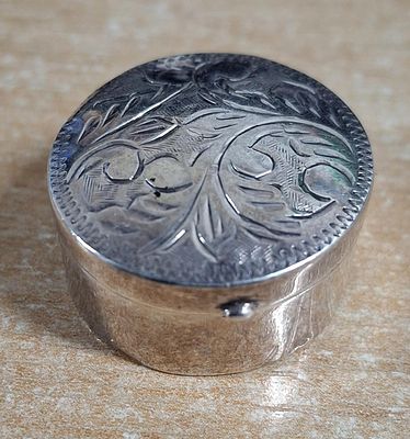 Small, circular 925 silver pill box with etched decoration to the lid