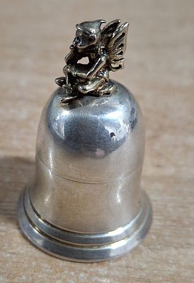 Charming small hallmarked 925 silver desk-top paper-weight in the form of a pixy sat on a bell