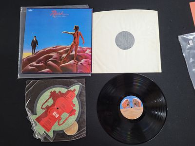 Two Rush records including a 12" LP "Hemisphere" and 7" Single "New World Man" (2)