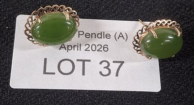 Pair of ovel Jade earrings set in unmarked gold coloured metal settings