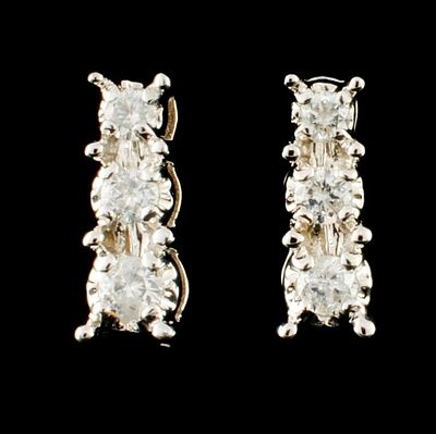 14K Gold 0.20ctw Diamond Earrings. These solid 14K white gold earrings feature round 