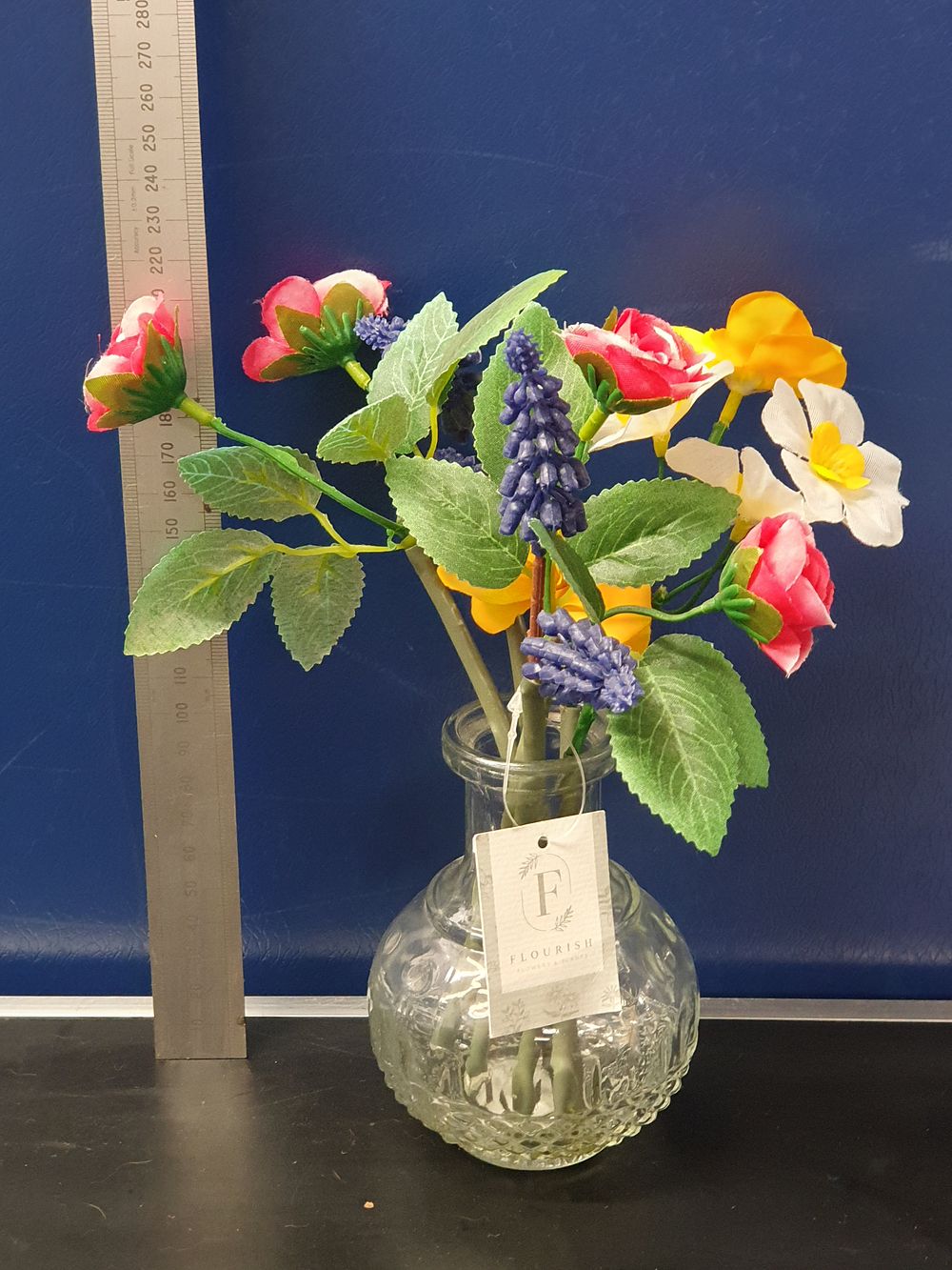 Lot 174: A Contemporary Artificial Floral Arrangement in a Textured Clear Glass Vase