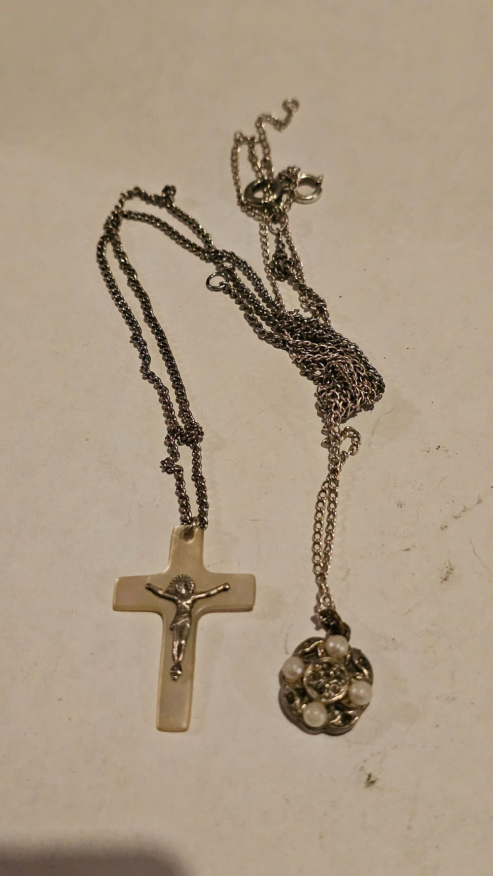Lot 206: An Antique Sterling Silver Necklace with Crucifix and Floral Cluster Pendants