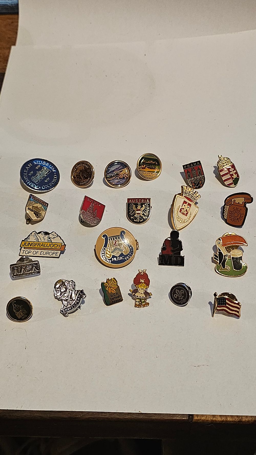 Lot 276: A Collection of 22 Assorted International Travel, Charitable, and Cultural Enamel Lapel Pins and Badges