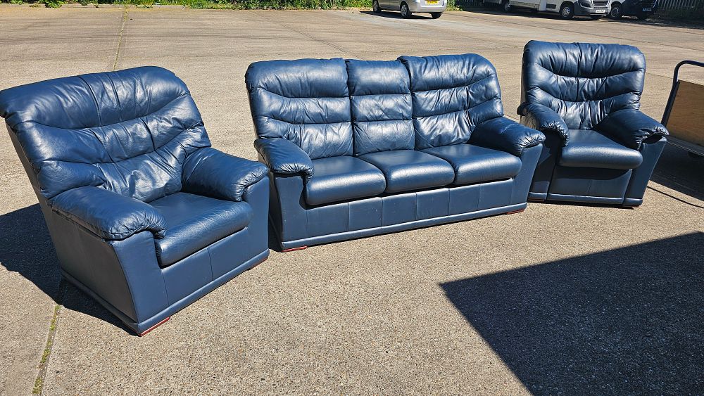 Lot 308: A contemporary three piece navy blue leather lounge suite