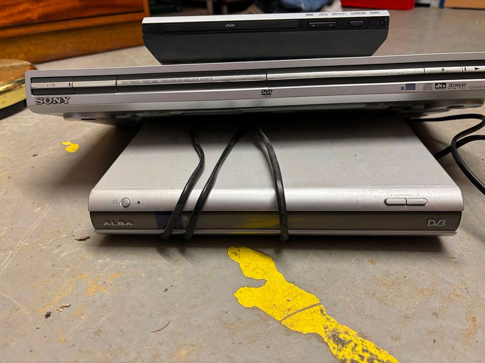 Lot 275: A Trio of Home Entertainment Electronics comprising a Sony DVD Player, an Alba Digital Receiver, and a Samsung Style DVD Player