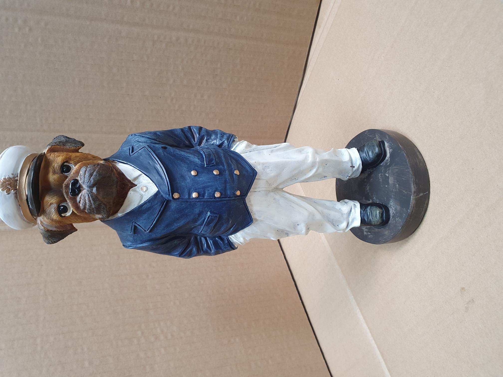 A Painted Composite Boxer Dog Naval Officer Figurine