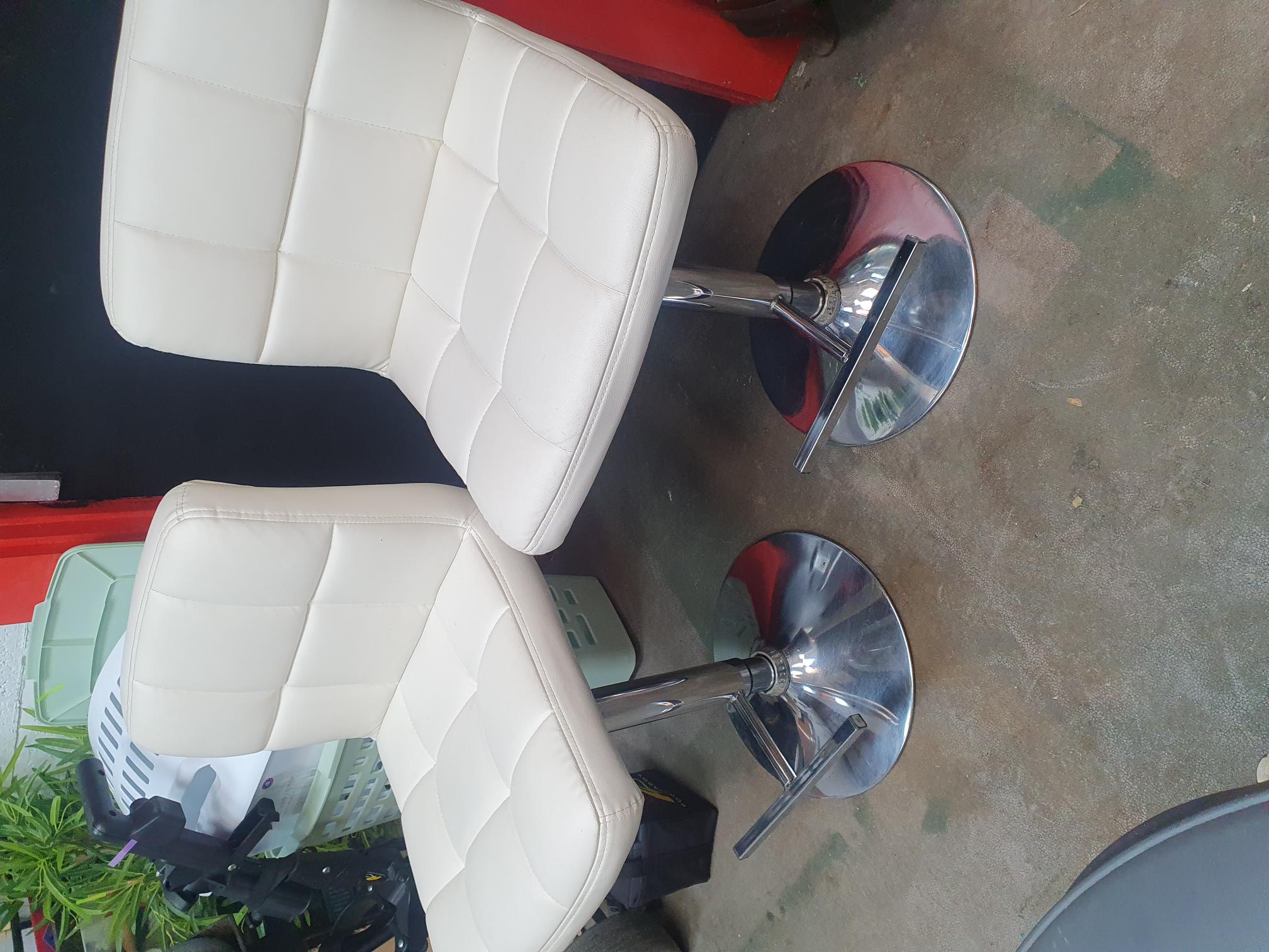 A Pair of Contemporary White Upholstered Swivel Bar Stools