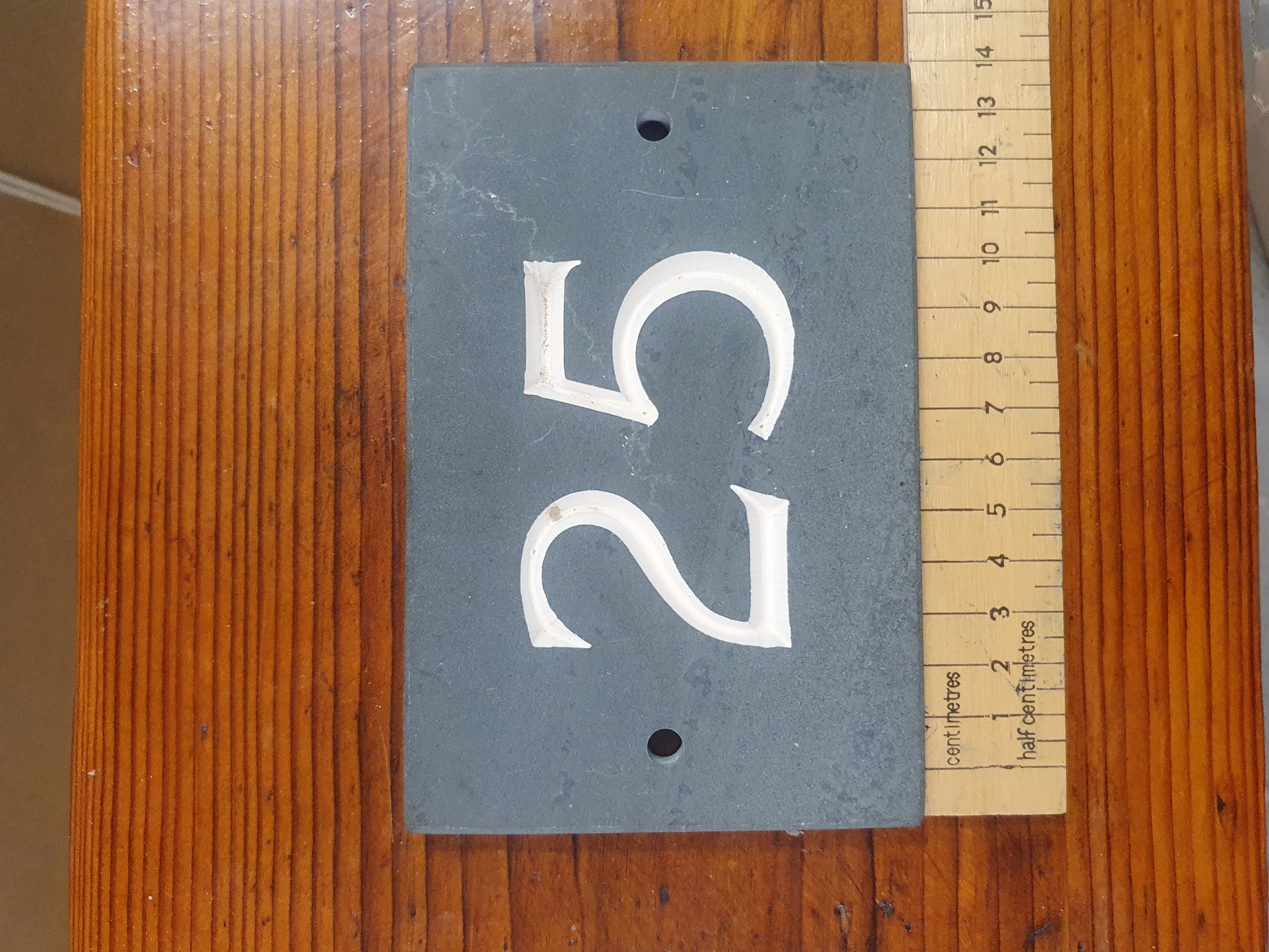 A Rectangular Slate House Number Plaque Featuring the Number 25