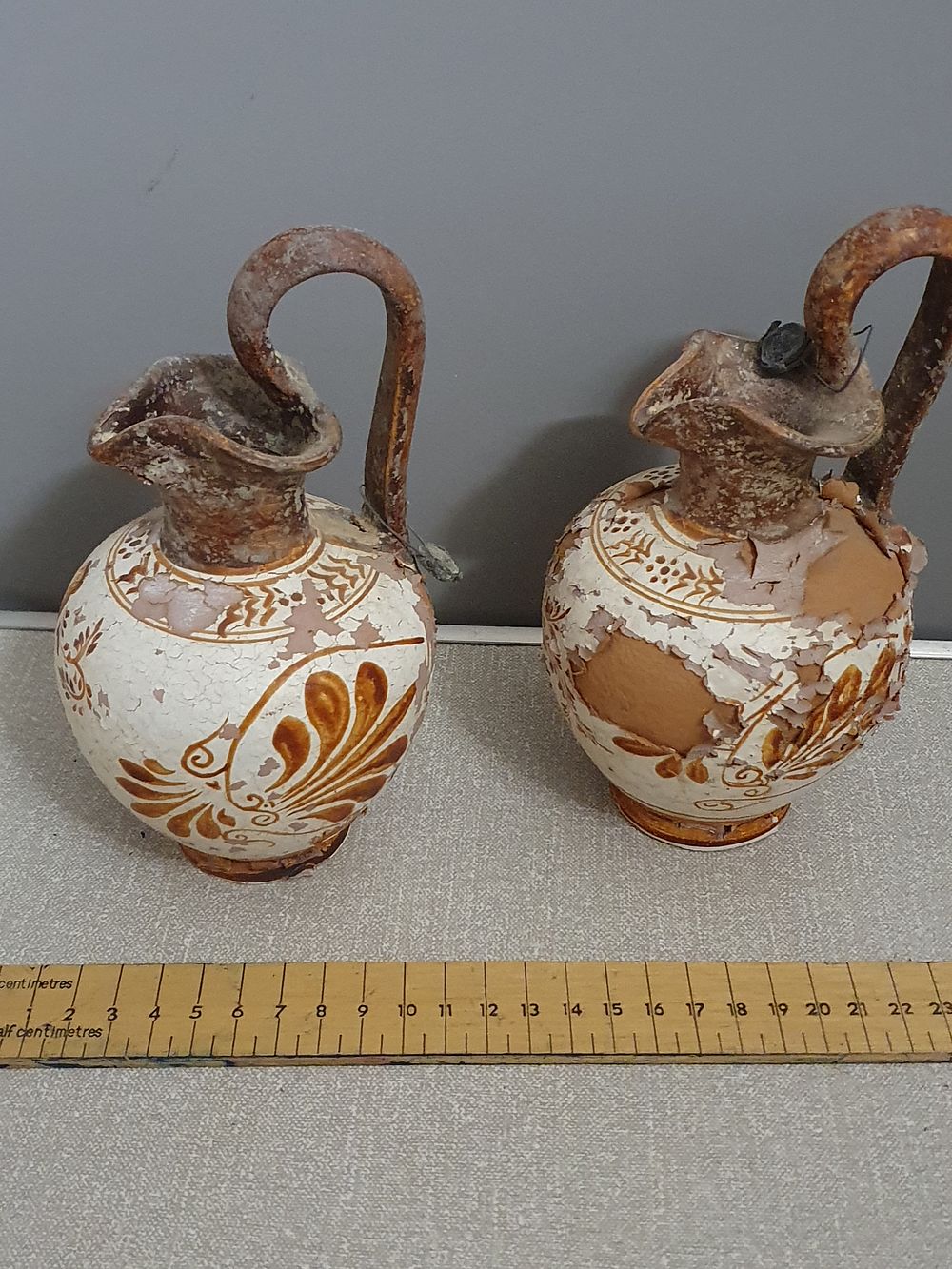 Lot 221: A Pair of White-Ground Style Terracotta Oinochoai