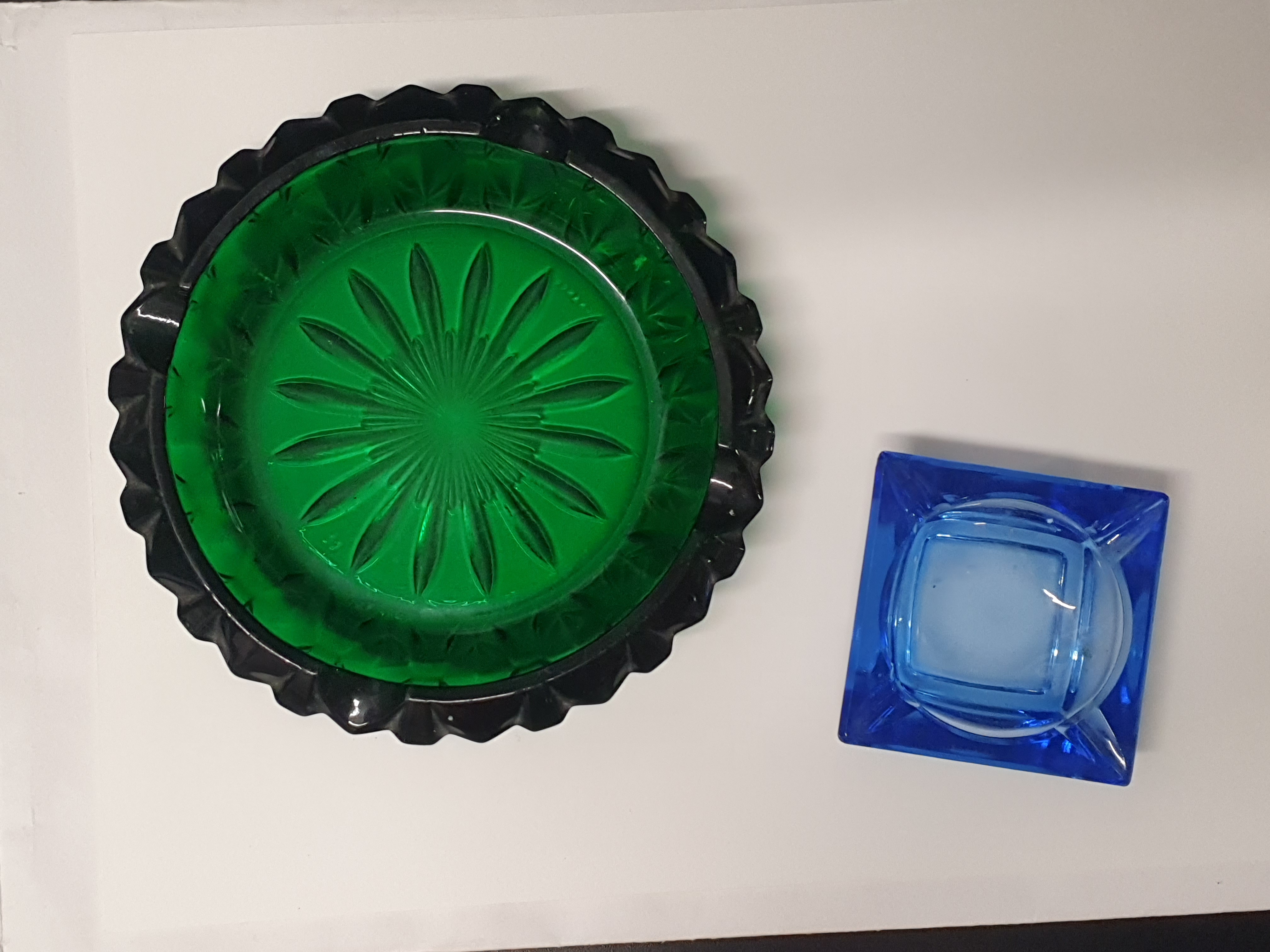 Two vintage pressed glass ashtrays including a French emerald green example