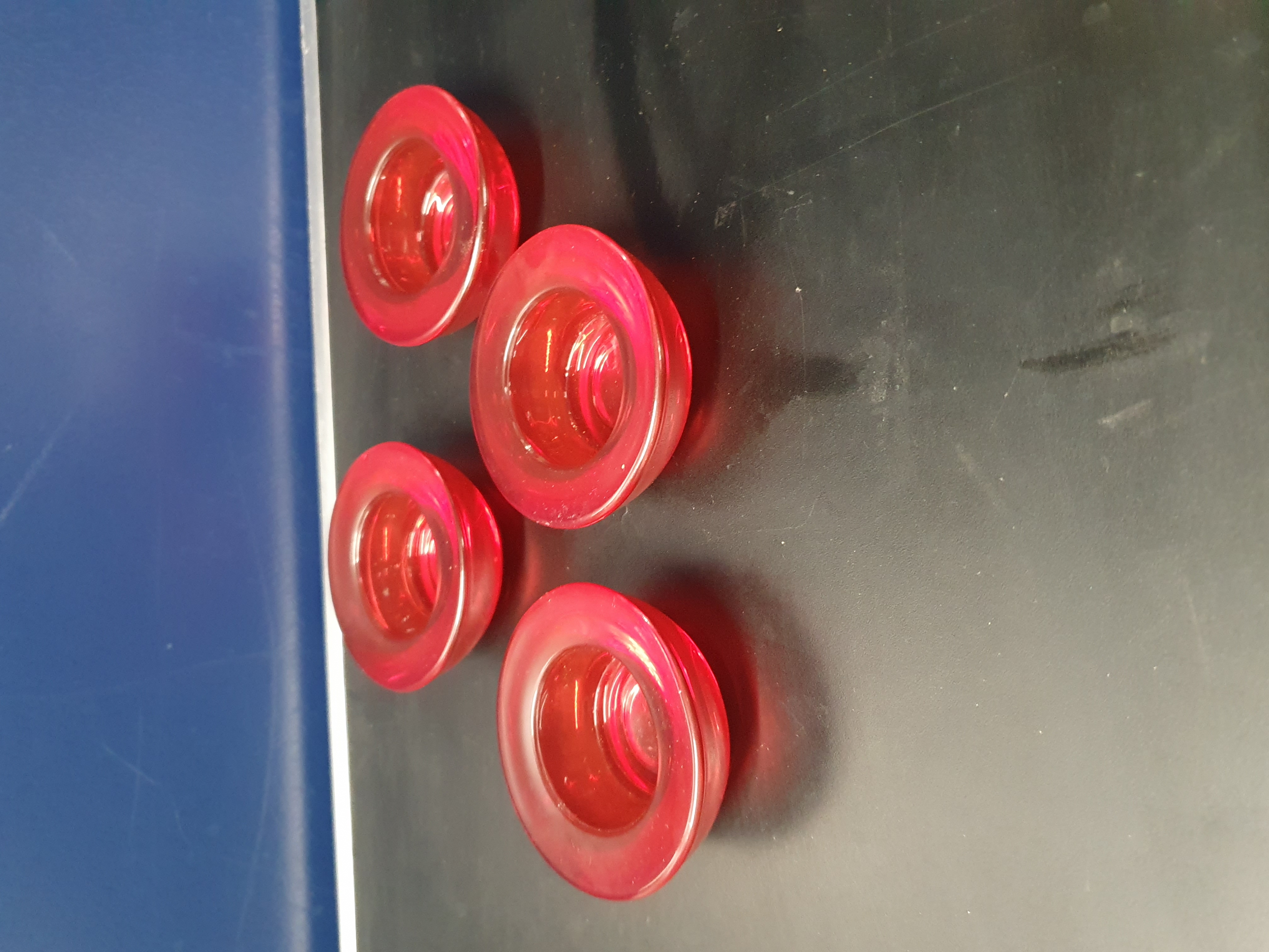 A Set of Four Ruby Red Glass Candle Holders