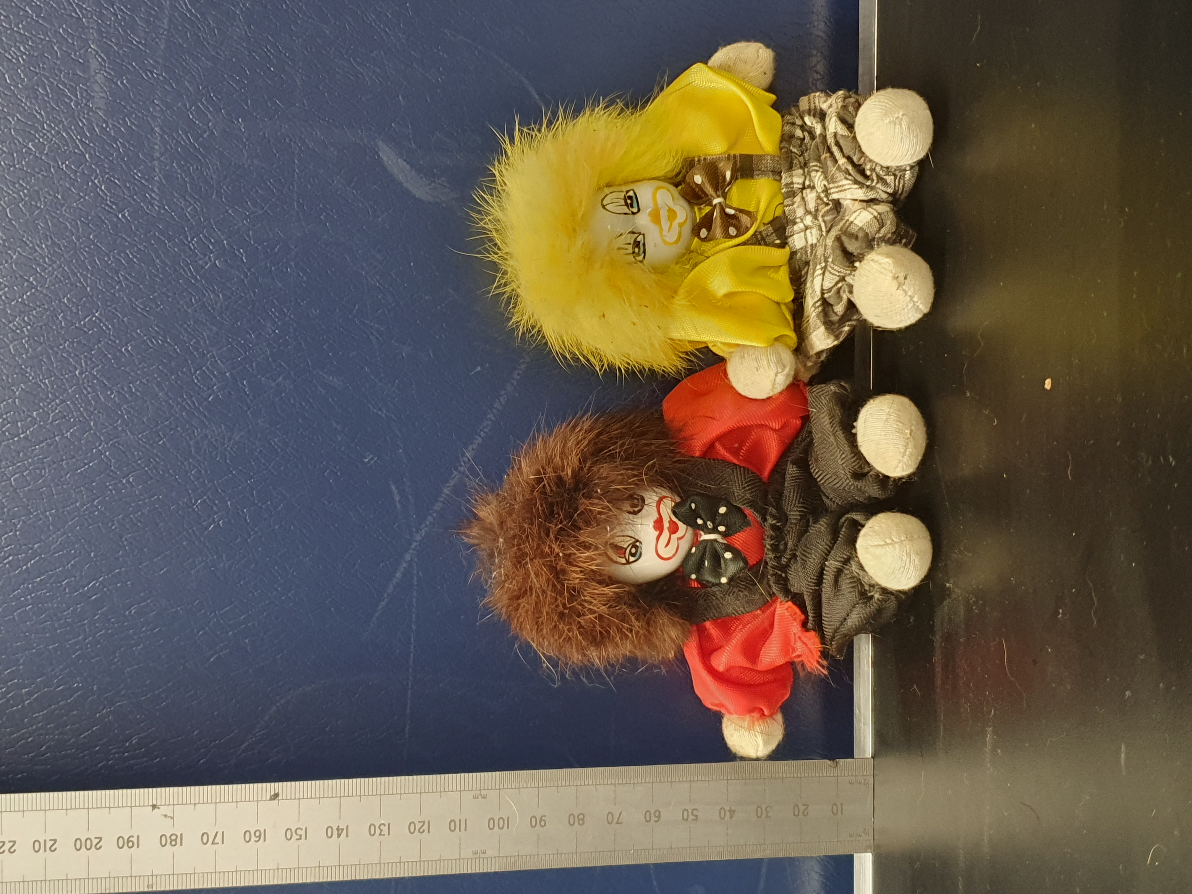 A Pair of Miniature Hand-Painted Porcelain-Headed Clown Dolls