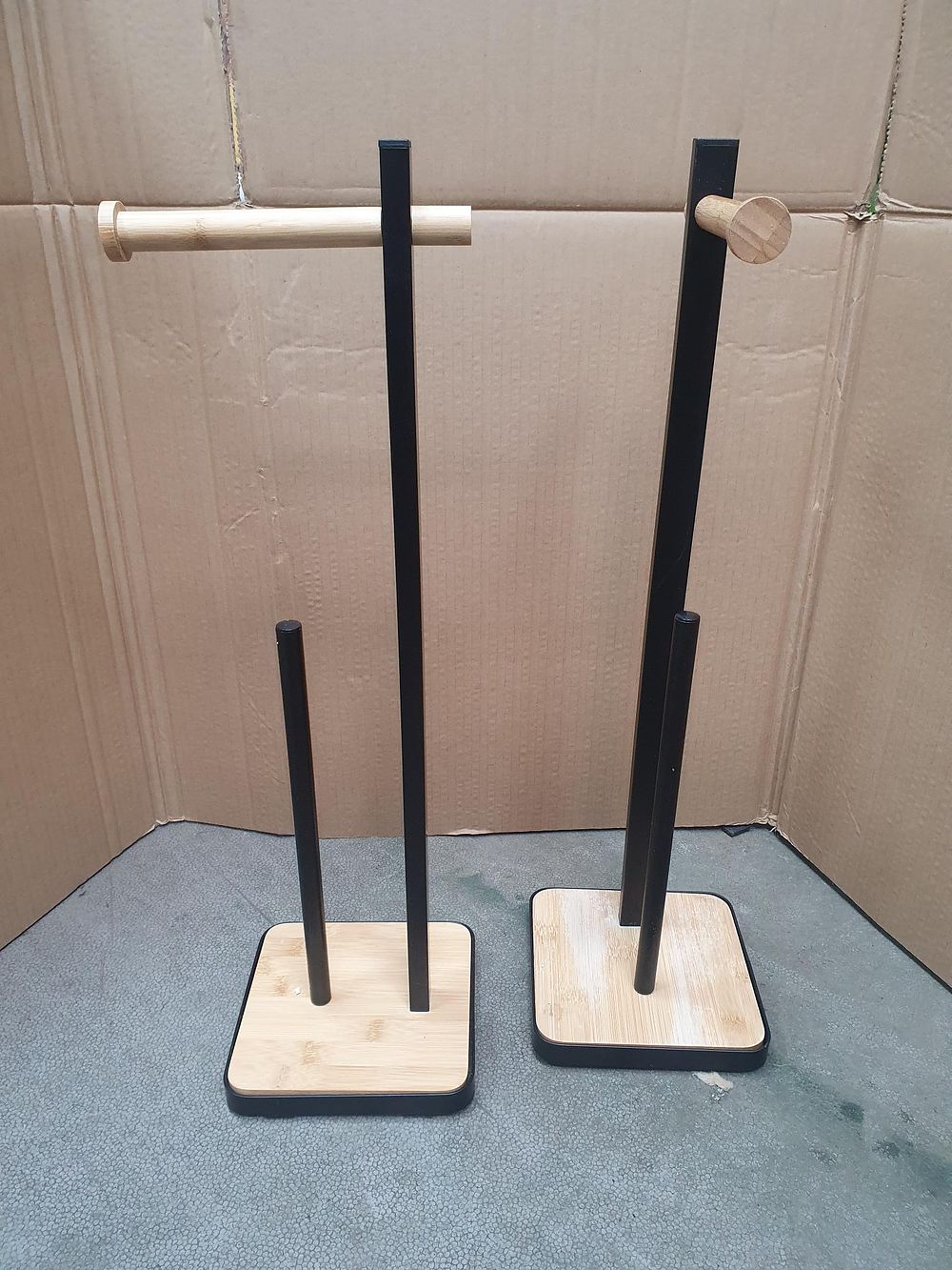 Lot 346: A Pair of Freestanding Matte Black Metal and Bamboo Toilet Roll Holders