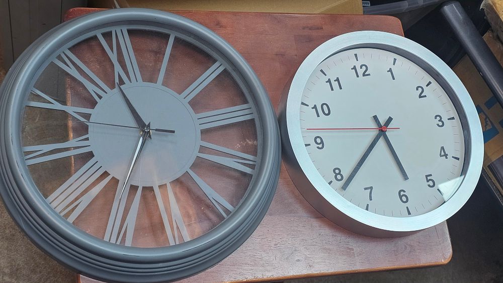 Lot 295: Two Modern Wall Clocks comprising a Large Grey Roman Numeral Clock and a Silver-Tone Arabic Numeral Clock