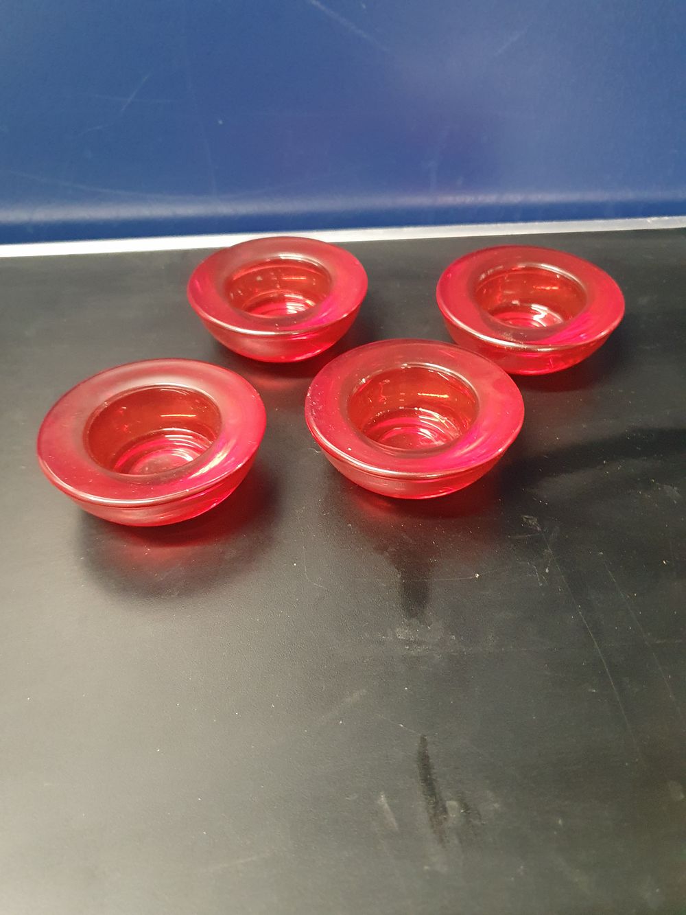 Lot 301: A Set of Four Ruby Red Glass Candle Holders