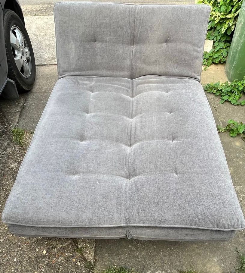 Lot 344: A contemporary grey fabric upholstered clic-clac convertible sofa bed