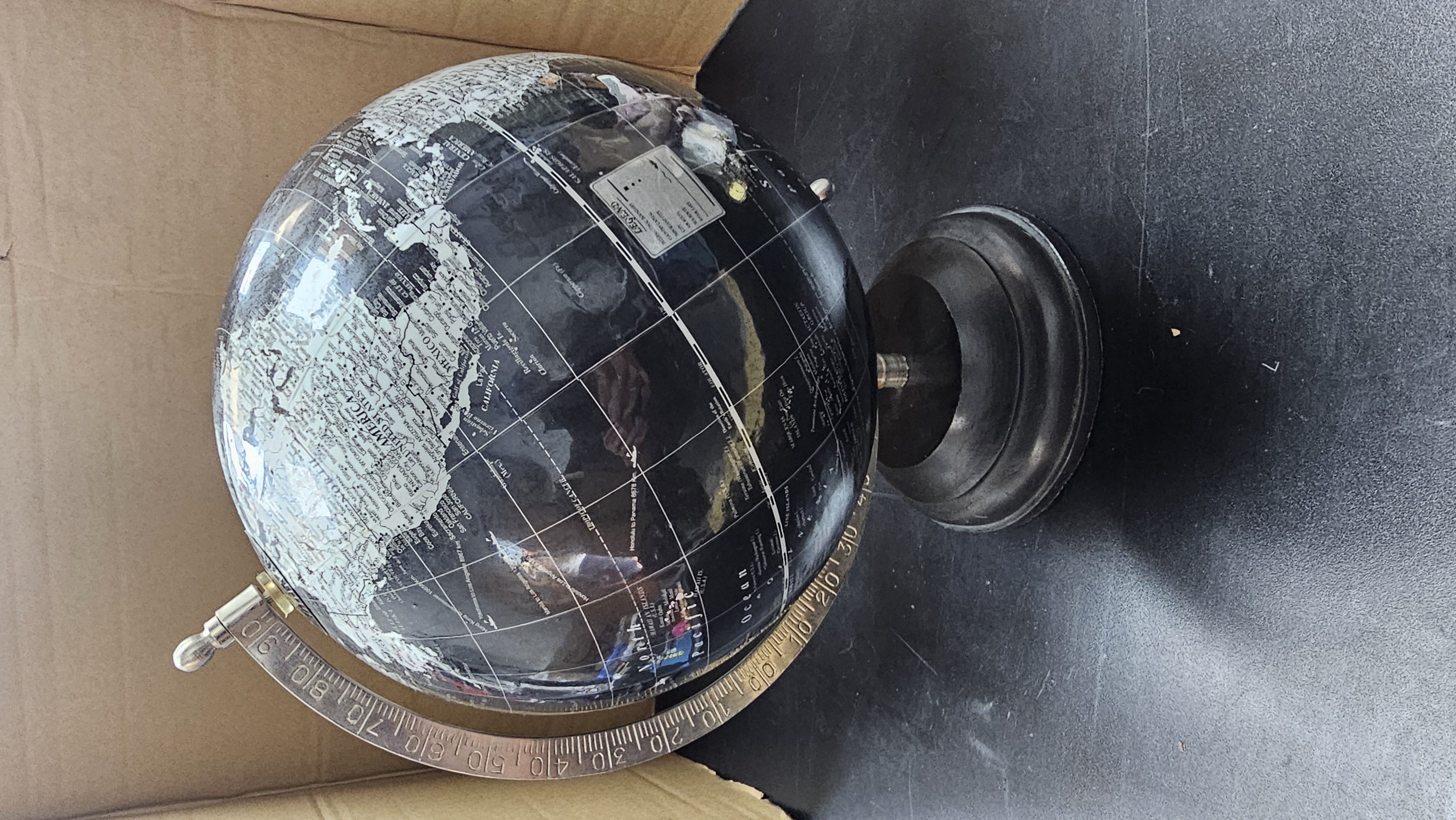 A Contemporary Black and Silver-Toned Decorative Tabletop Terrestrial Globe