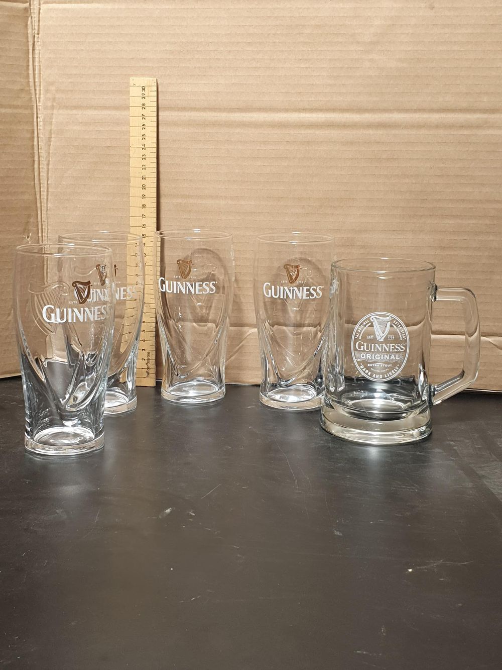 Lot 241: A Set of Five Guinness Branded Beer Vessels including Gravity Pint Glasses