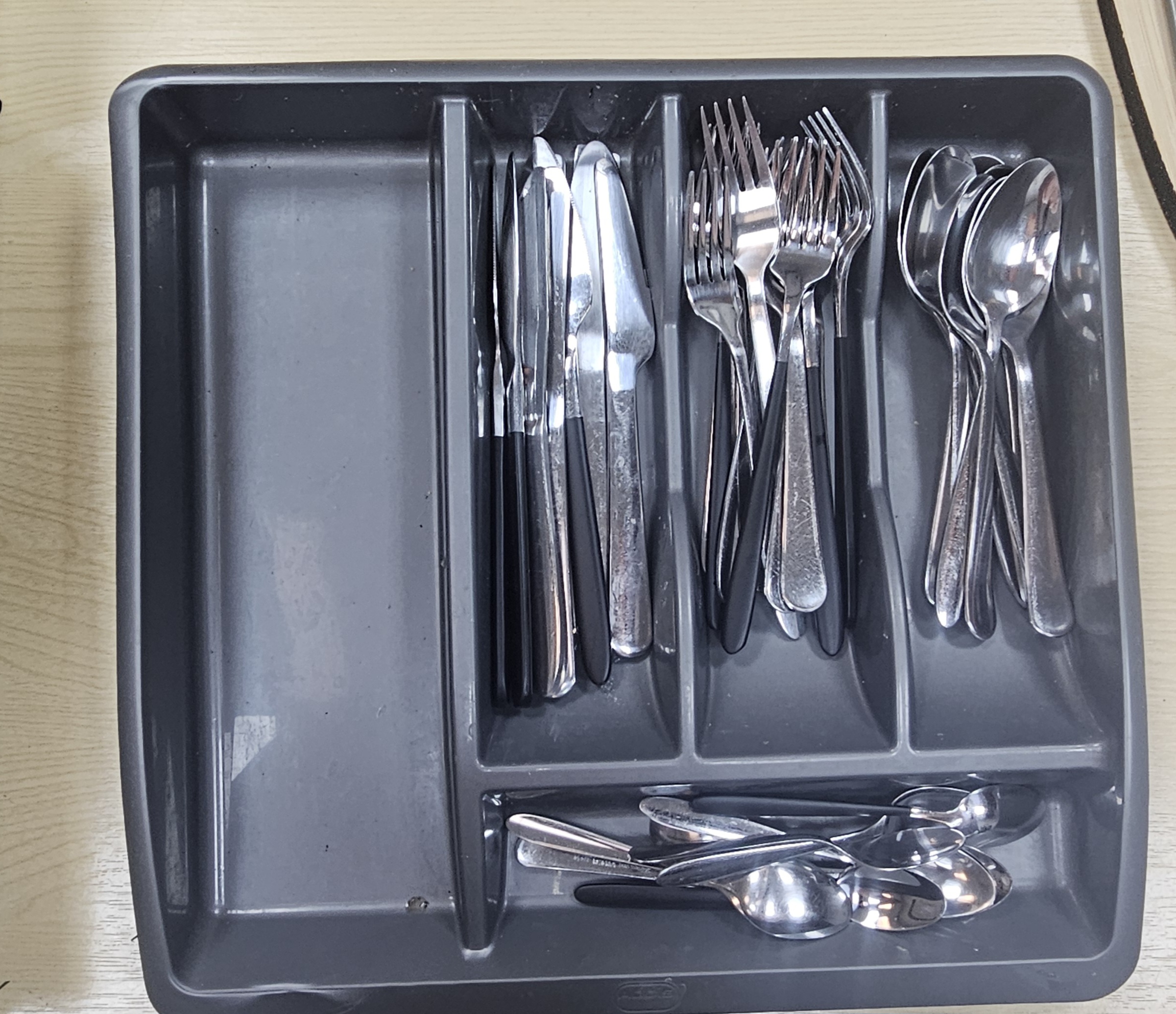A Collection of Mixed Stainless Steel Flatware in an Addis Storage Tray
