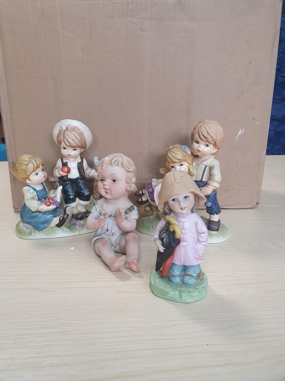 Lot 251: A Collection of Four Bisque Porcelain Pastoral Children Figurines, Some Believed to be Of German Origin - Used Condition