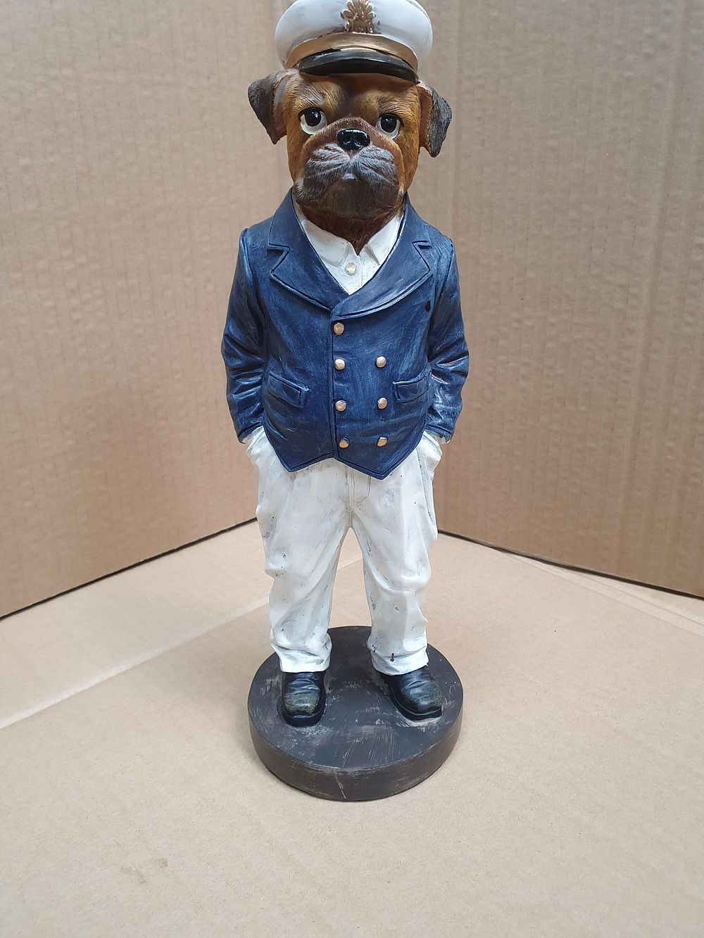 Lot 276: A Painted Composite Boxer Dog Naval Officer Figurine