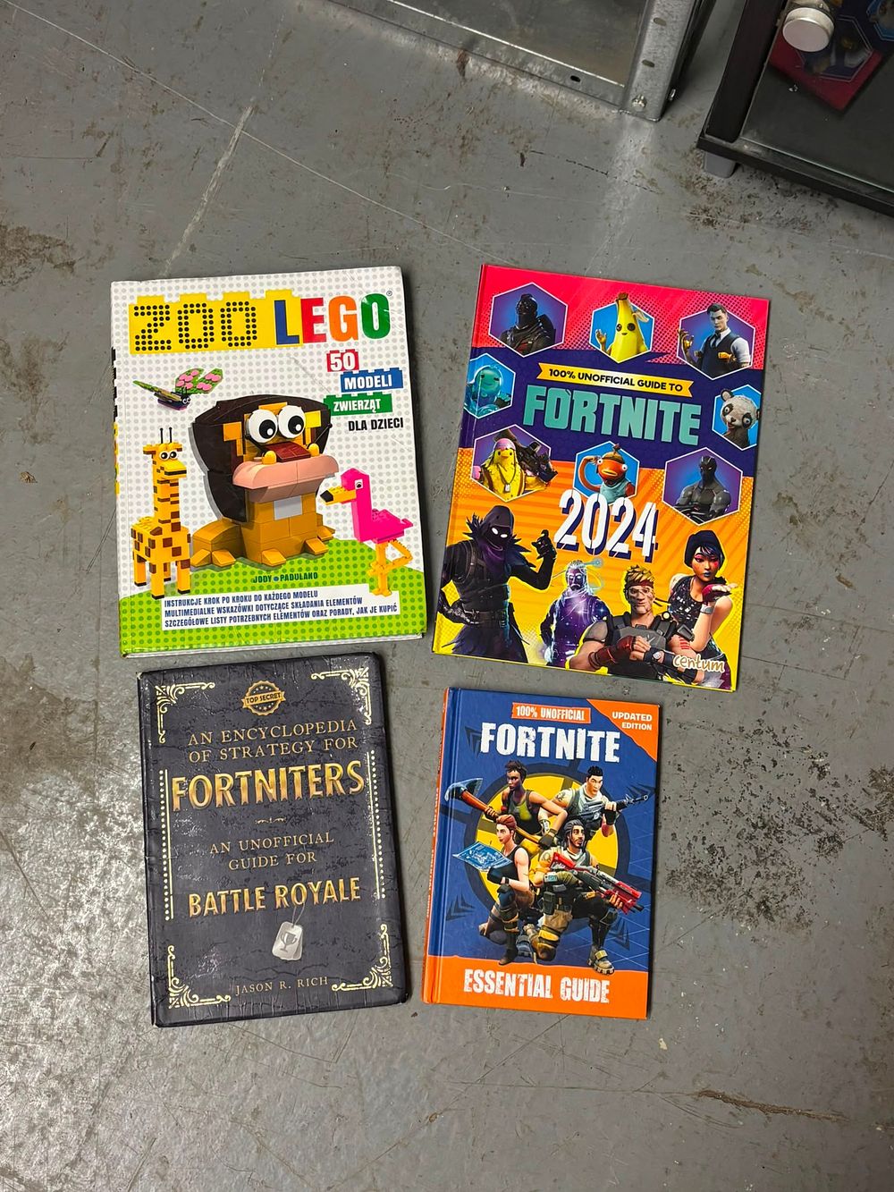 Lot 277: A Collection of Fortnite Strategy Guides and LEGO Instruction Manuals. Centum and others, 2017-2024.