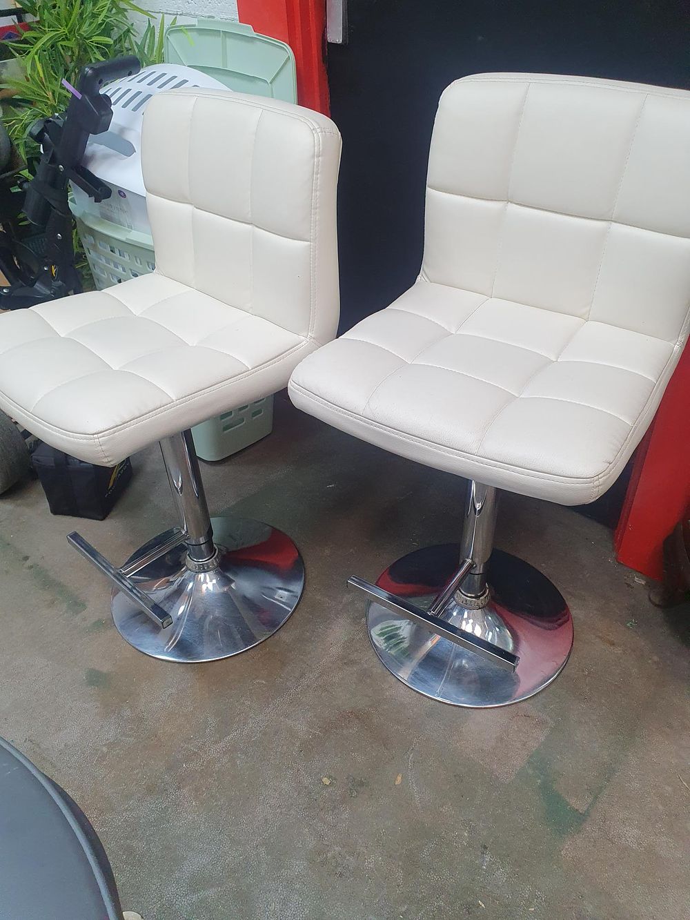 Lot 223: A Pair of Contemporary White Upholstered Swivel Bar Stools