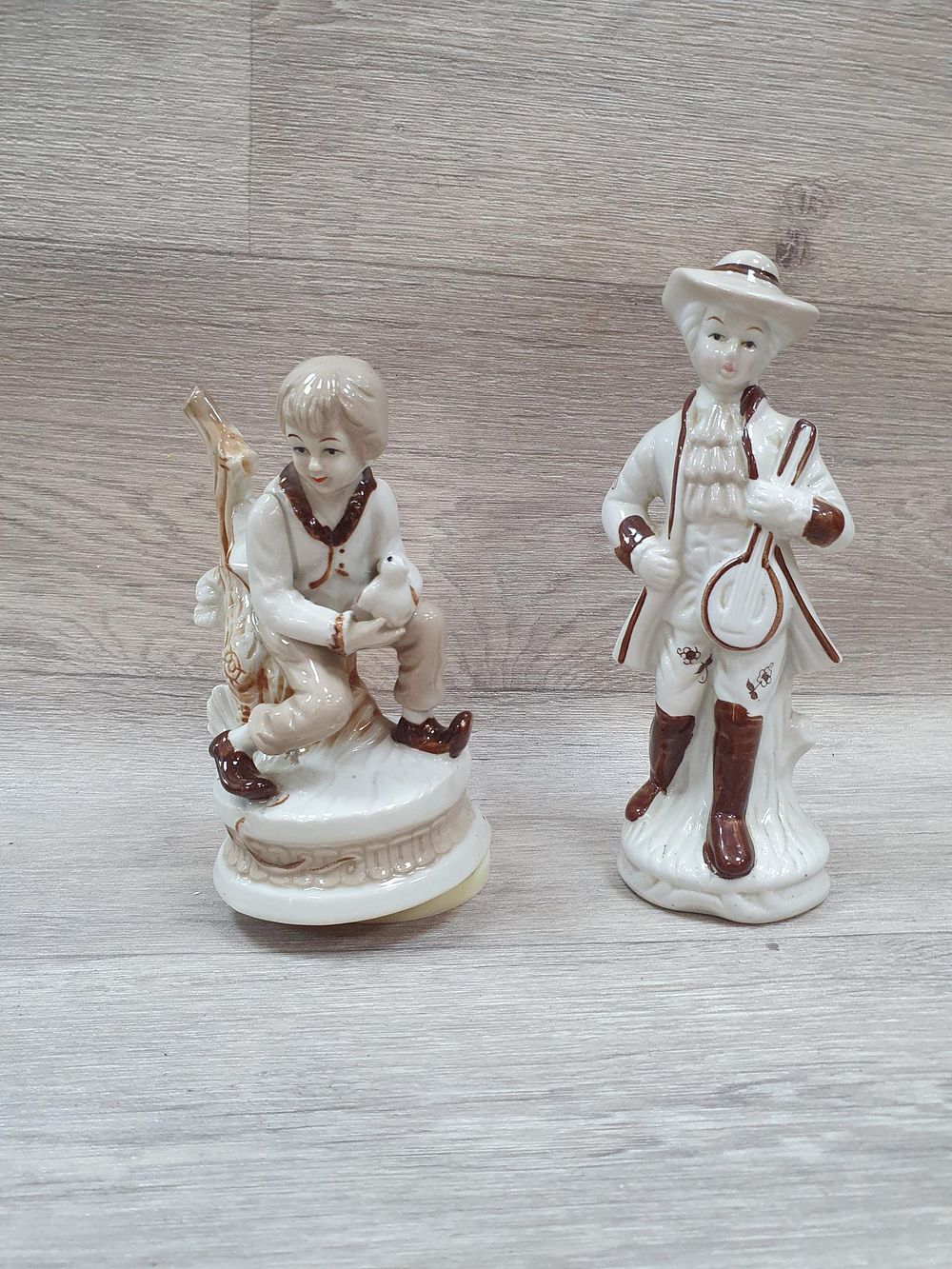 Lot 267: A Pair of Glazed White and Brown Porcelain Figurines - One is A Musical Figurine - In working order