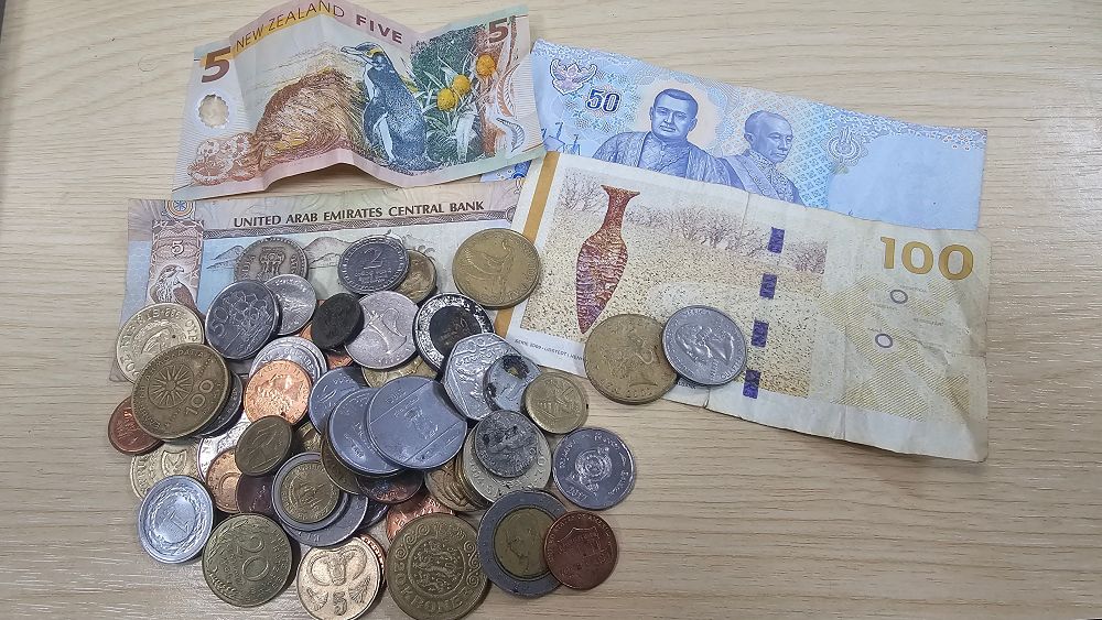 Lot 186: Collection of International Banknotes and Coins inc over 11 NZ Dollars