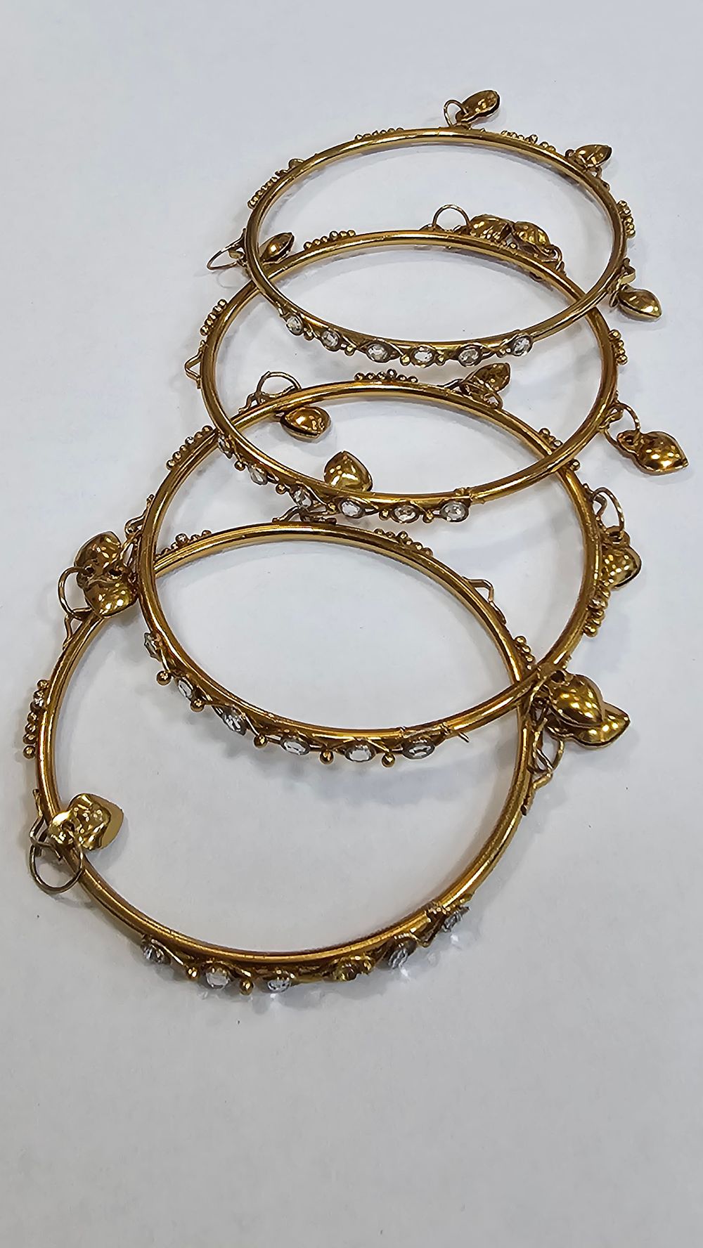 Lot 251: Set of Four Gold-Tone Beaded Bangles with Heart Charms - Very Good Condition