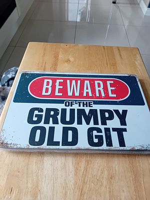 Novelty Metal Wall Sign Beware Of The Grumpy Old Git. A rectangular novelty metal wall sign 