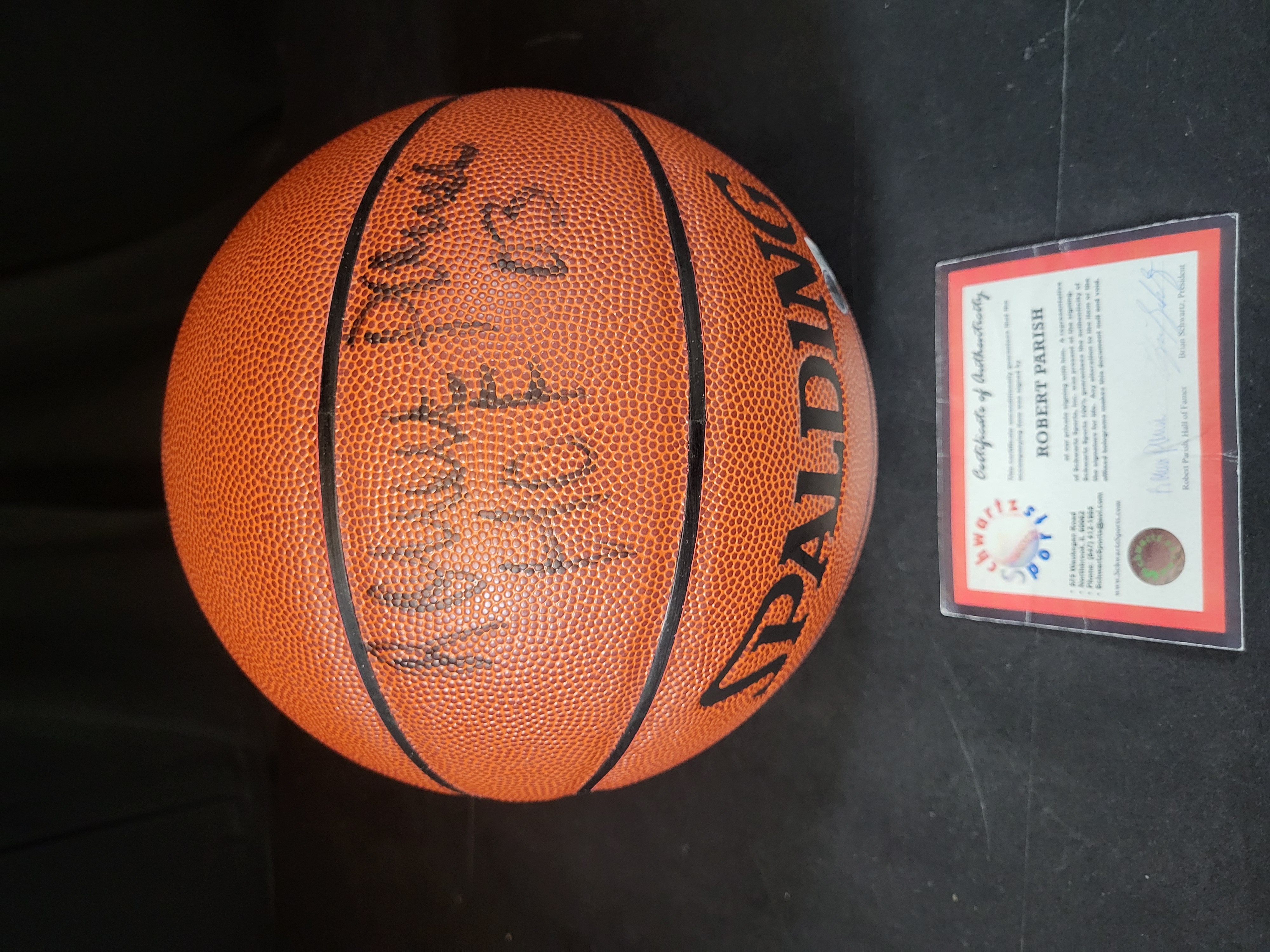 I03087 | Robert Parish Autographed Spalding Indoor Outdoor Basketball with HOF 03 Inscription and Dual Authentication