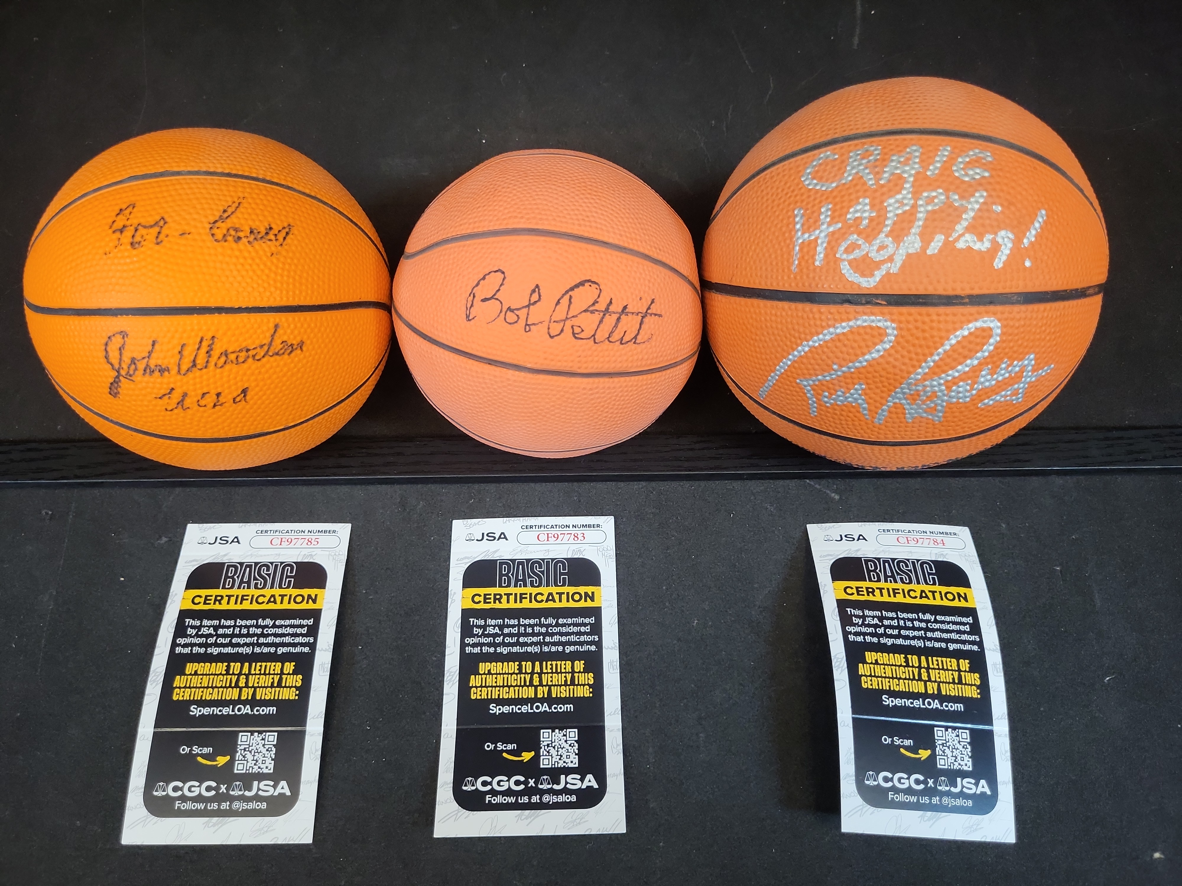 I03444 | A Trio of Autographed Basketball Legend Mini-Basketballs Including John Wooden, Bob Pettit, and Rick Barry with JSA COAs