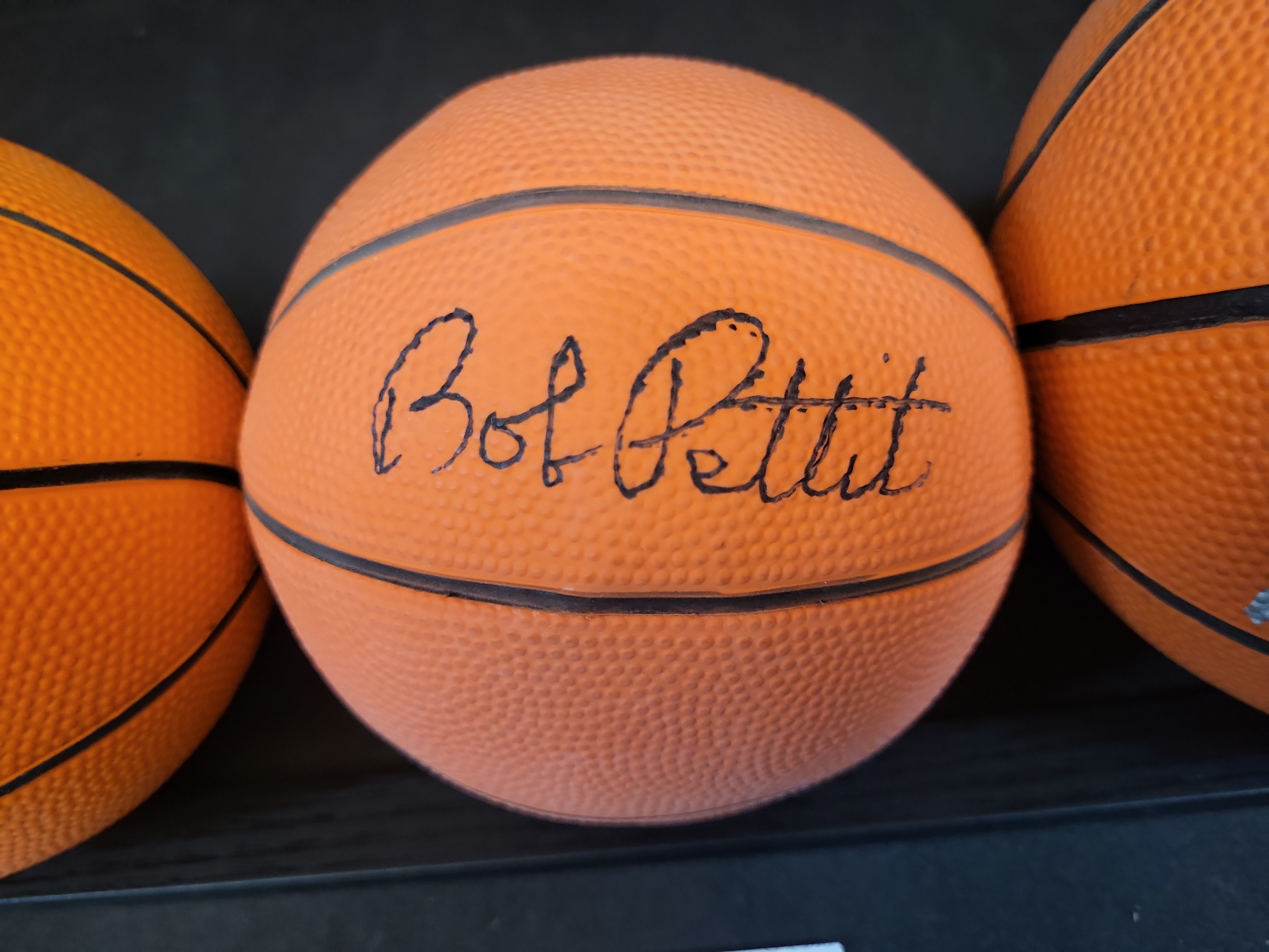 I03444 | A Trio of Autographed Basketball Legend Mini-Basketballs Including John Wooden, Bob Pettit, and Rick Barry with JSA COAs