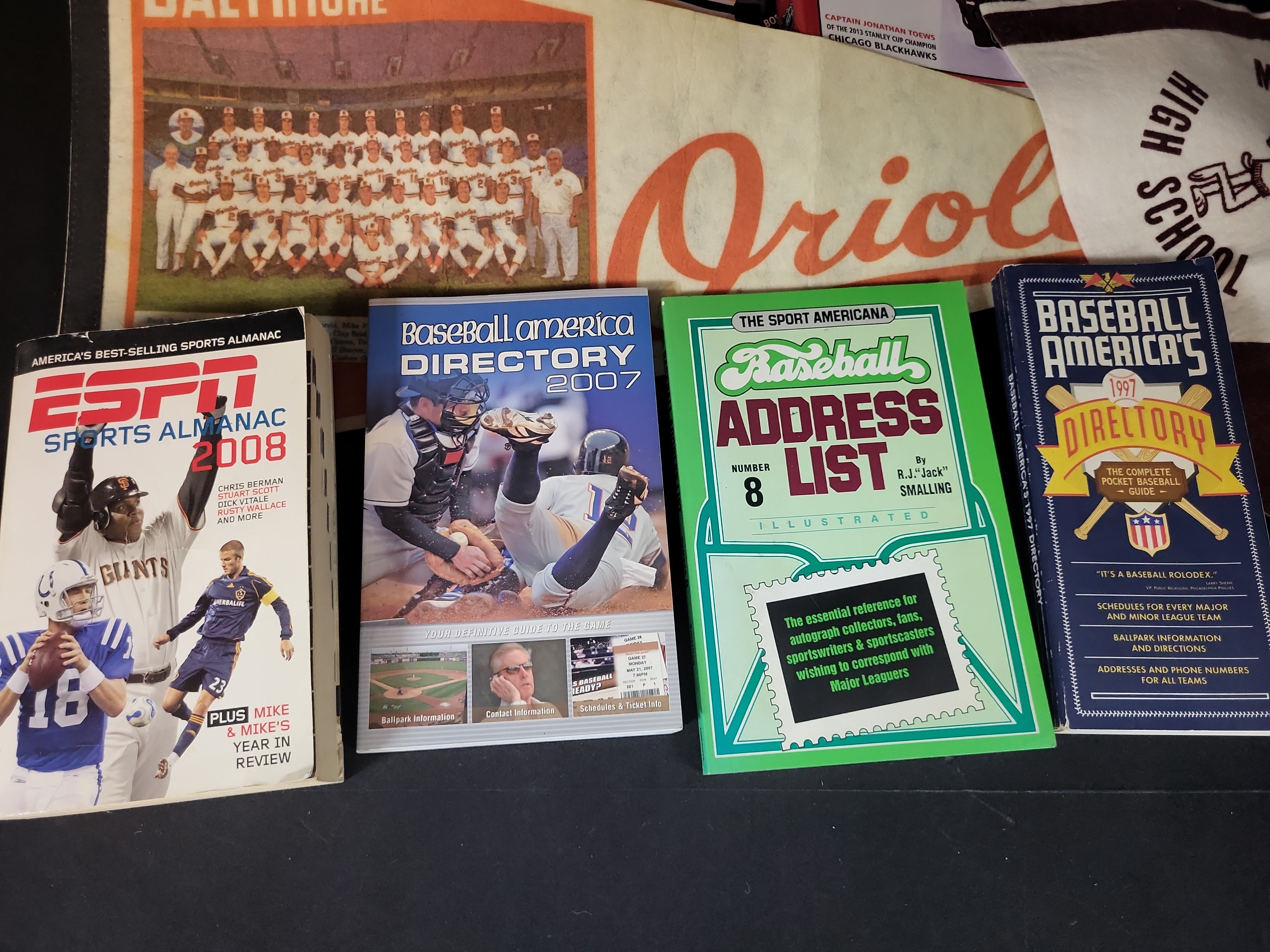 I03047 | A Collection of Sports Memorabilia Including Autographed Photographs, Vintage Pennants, and Reference Publications