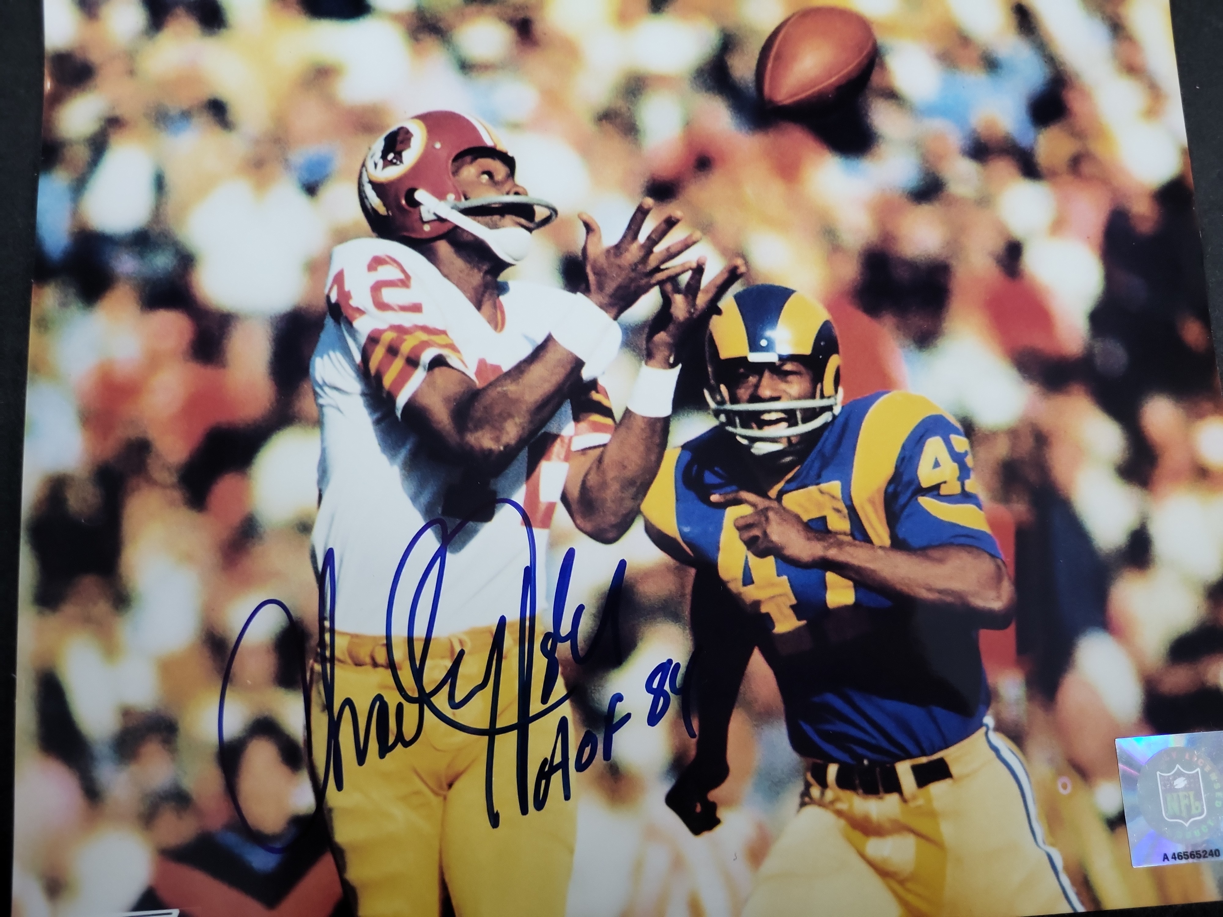 I03410 | A Lot of Four Autographed NFL Football Photographs Featuring Gale Sayers, Charley Taylor, Ken Houston, and Joe Jacoby