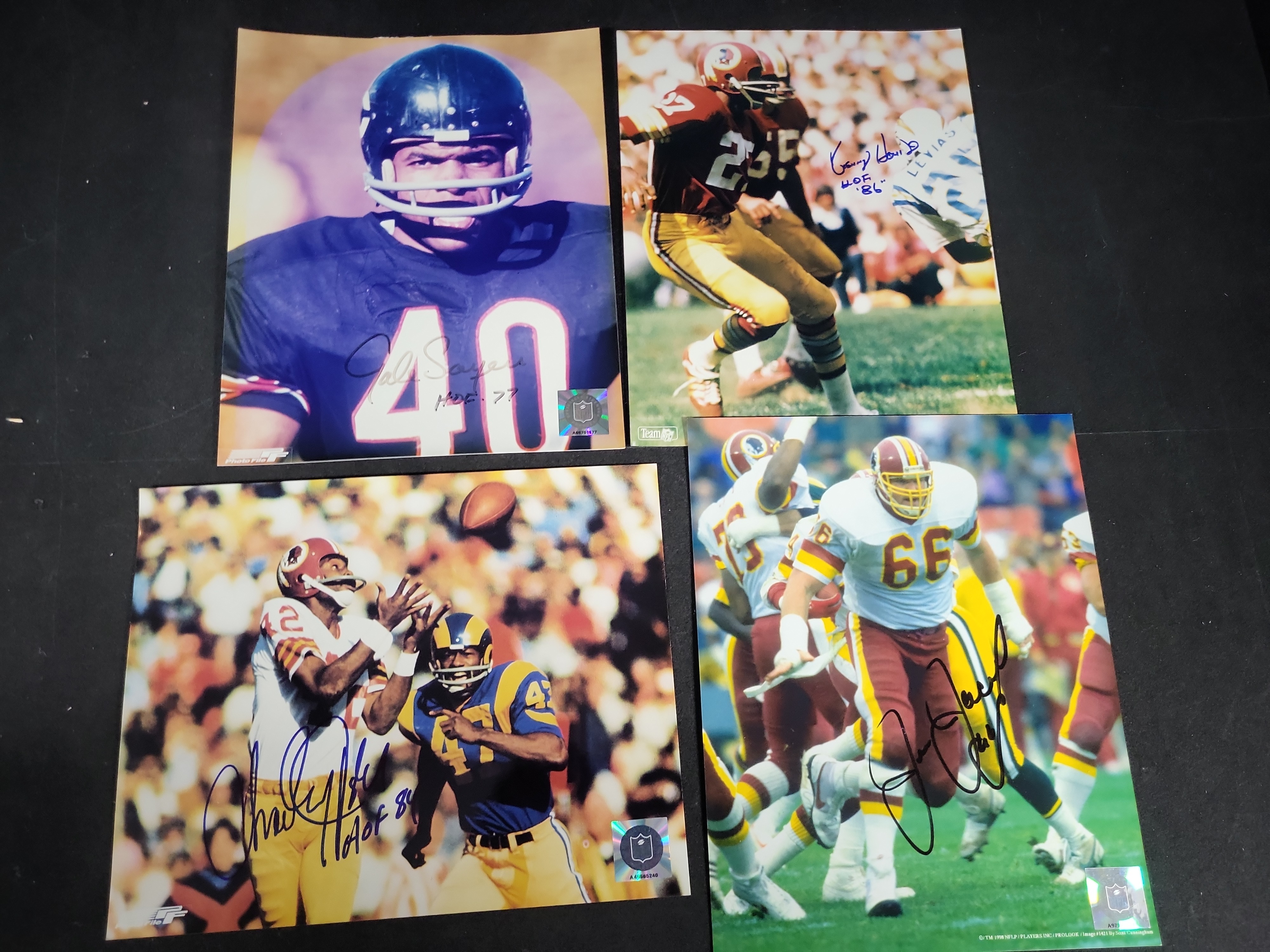 I03410 | A Lot of Four Autographed NFL Football Photographs Featuring Gale Sayers, Charley Taylor, Ken Houston, and Joe Jacoby