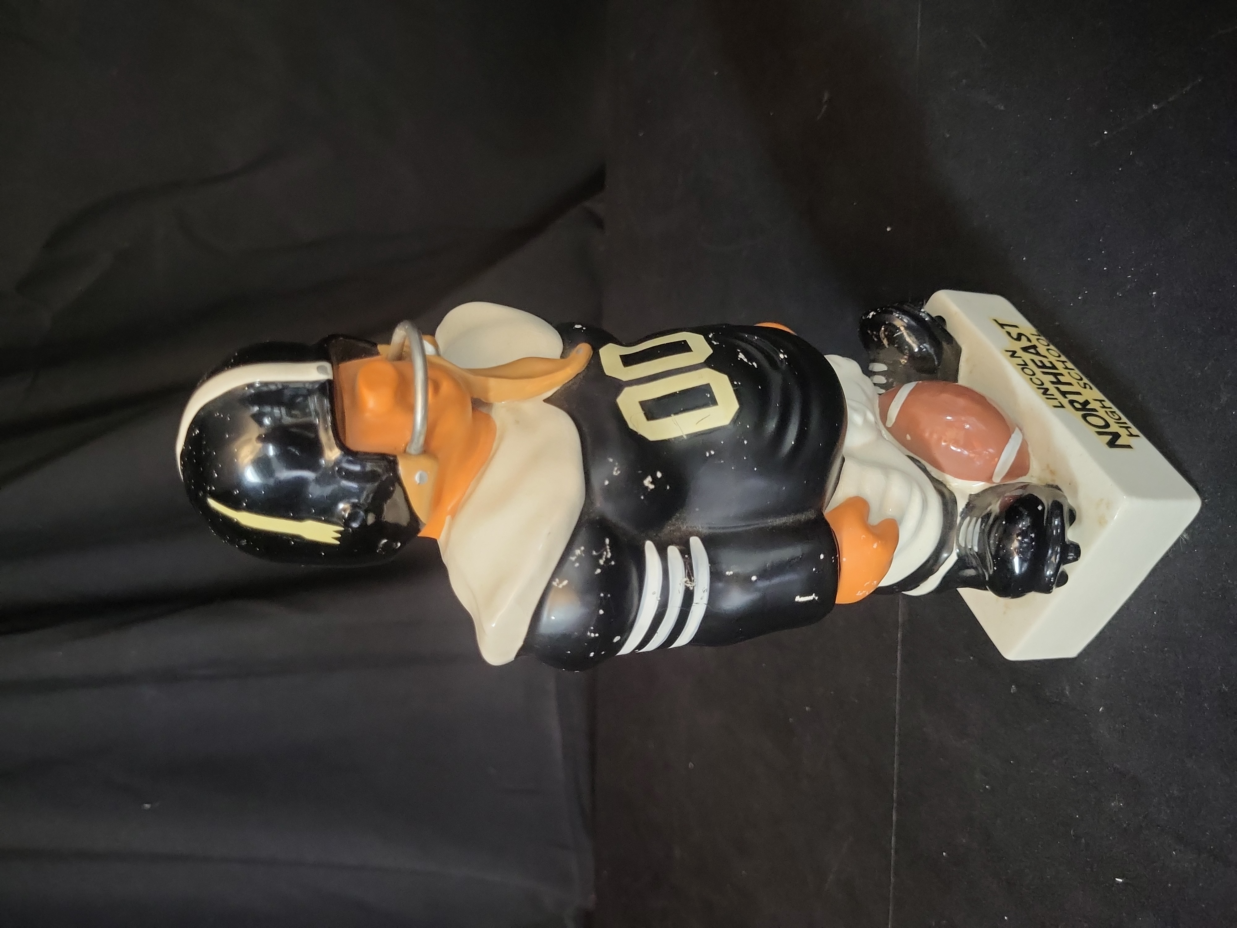 I03258 | Vintage Lincoln Northeast High School Ceramic Football Player Promotional Coin Bank Attributed to Fred Kail