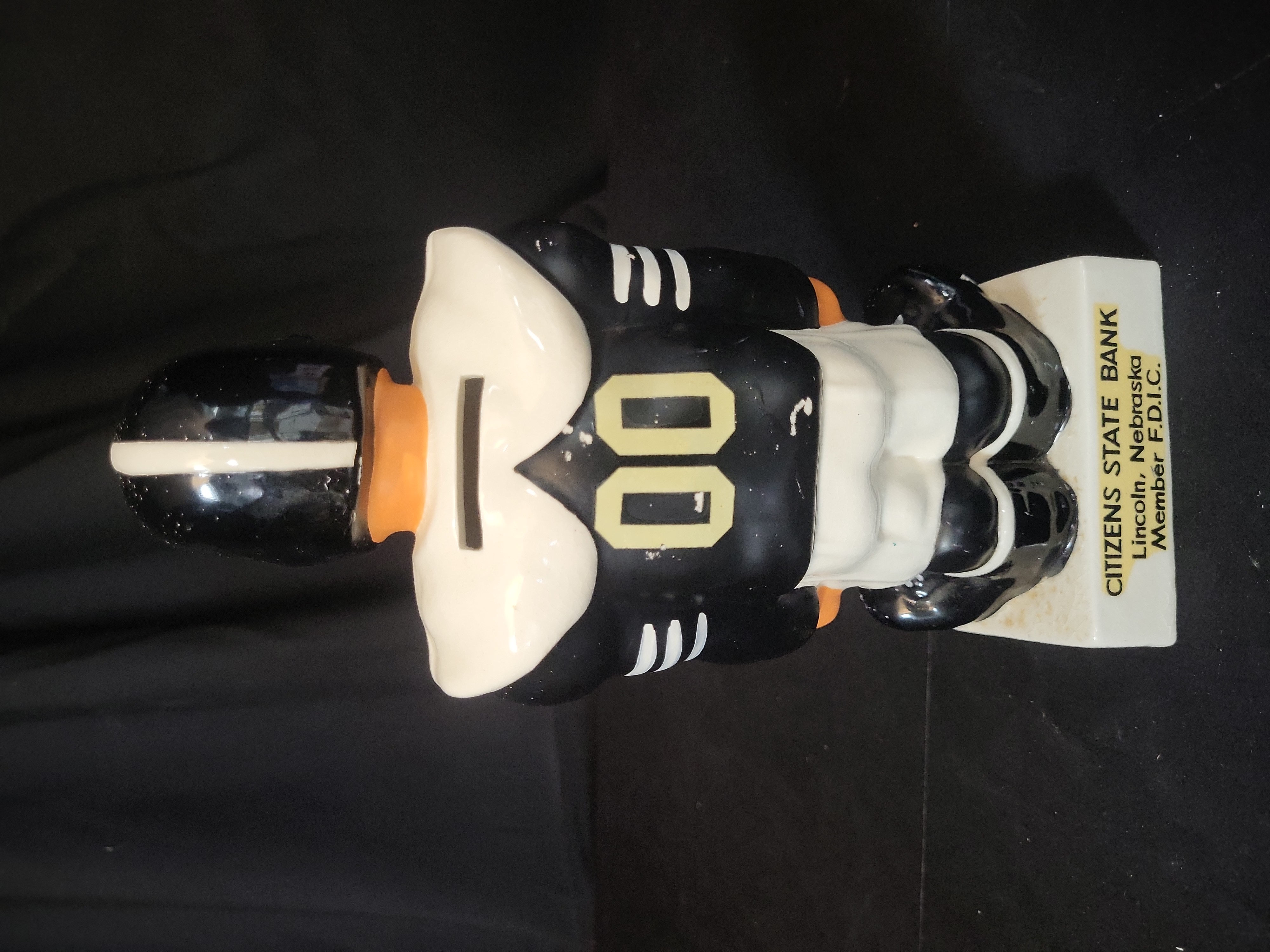 I03258 | Vintage Lincoln Northeast High School Ceramic Football Player Promotional Coin Bank Attributed to Fred Kail
