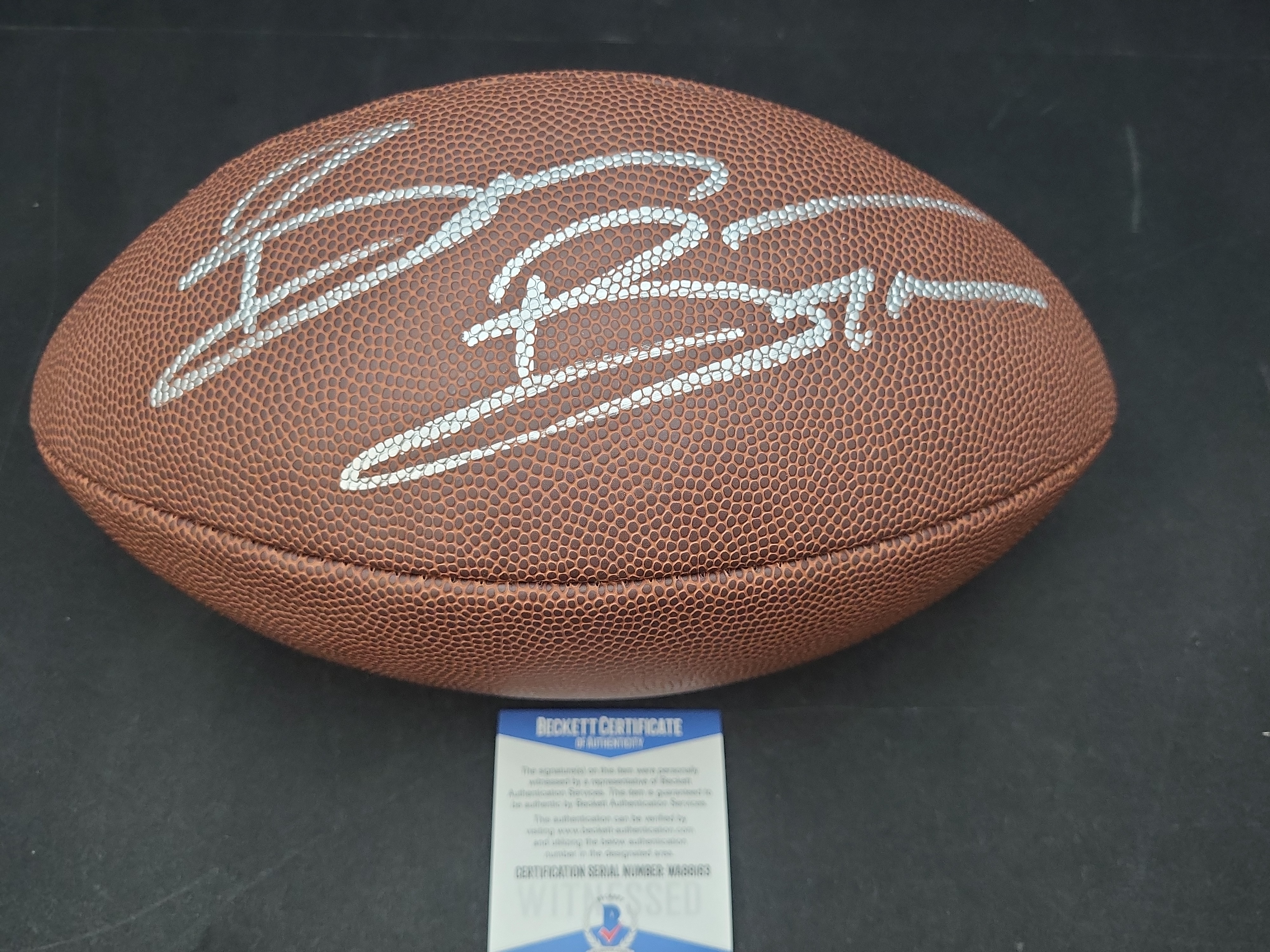 I03571 | Brian Bosworth Signed Wilson Super Grip Official Size NFL Football Beckett Witnessed Authentication