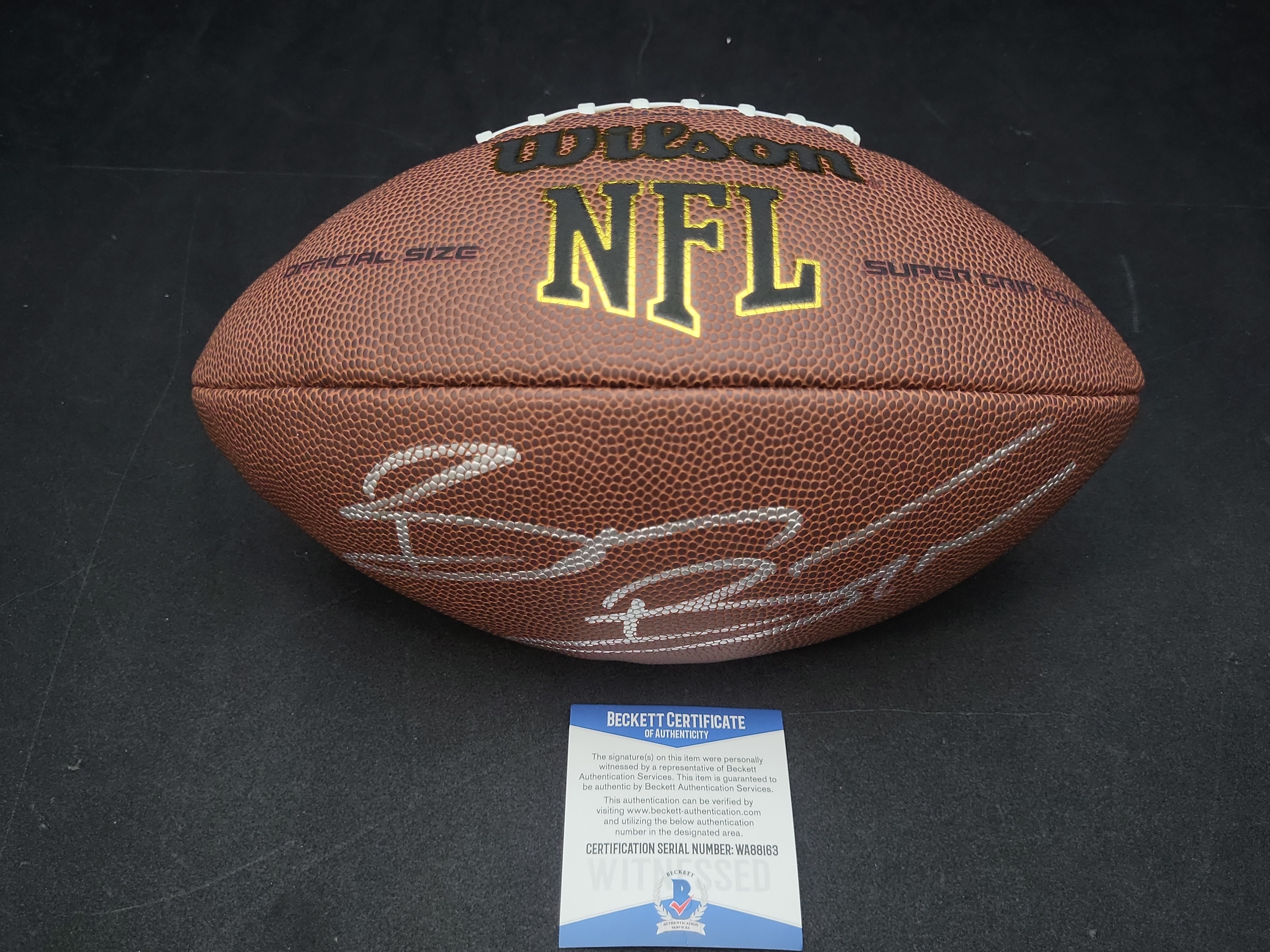 I03571 | Brian Bosworth Signed Wilson Super Grip Official Size NFL Football Beckett Witnessed Authentication