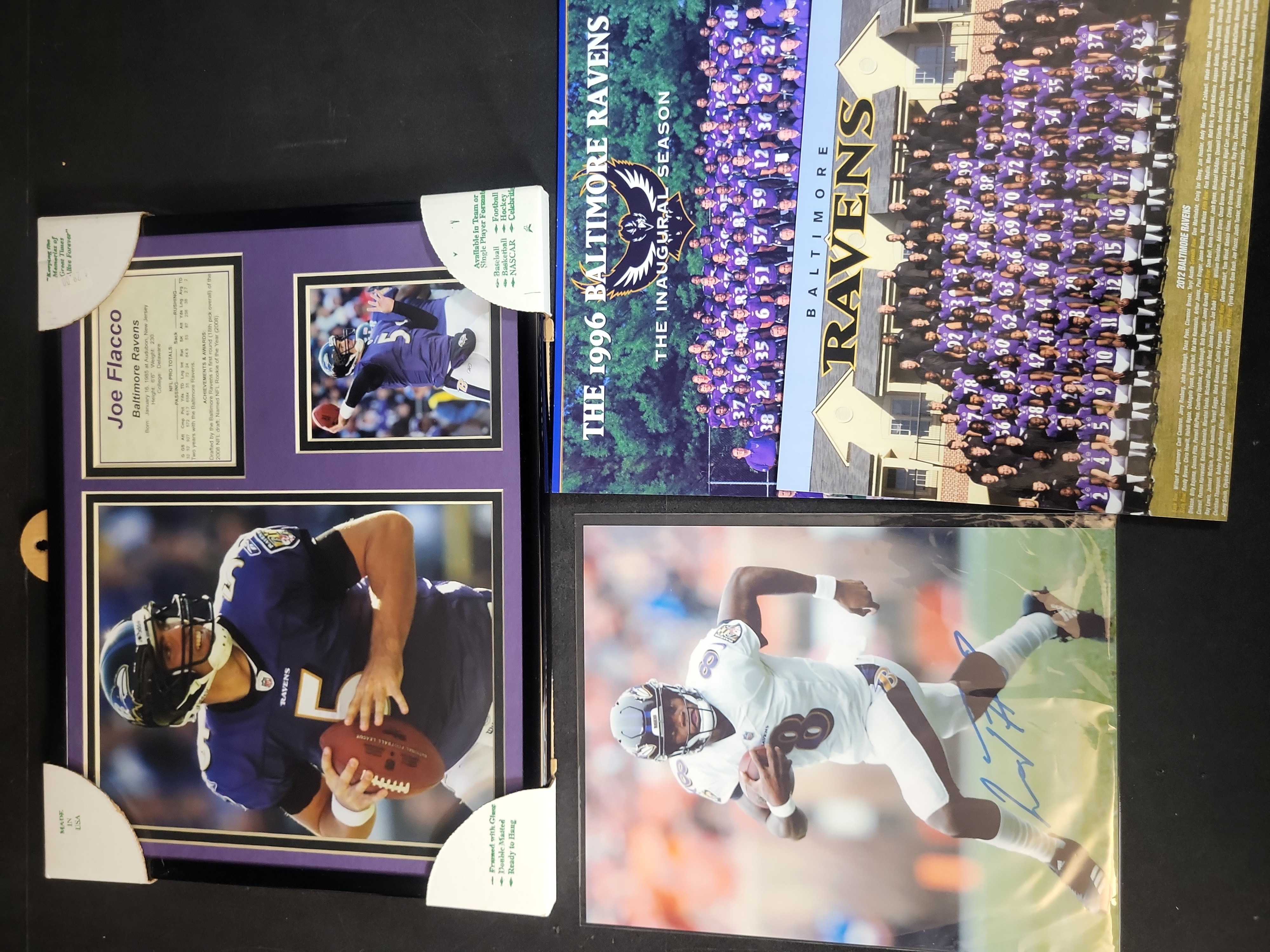 I03645 | A Collection of Baltimore Ravens Memorabilia Including Framed Joe Flacco Plaque and Autographed Lamar Jackson Photo