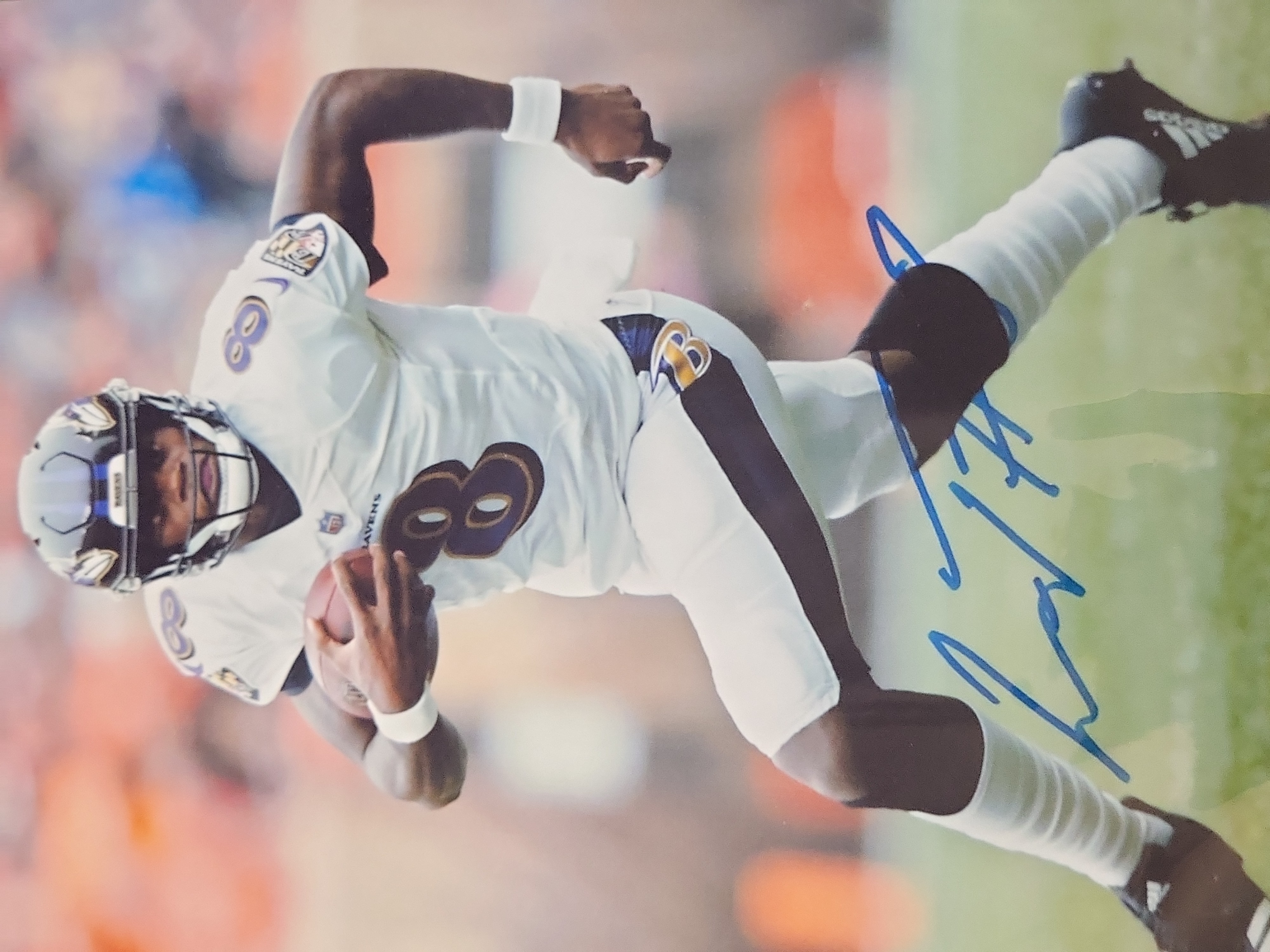 I03645 | A Collection of Baltimore Ravens Memorabilia Including Framed Joe Flacco Plaque and Autographed Lamar Jackson Photo