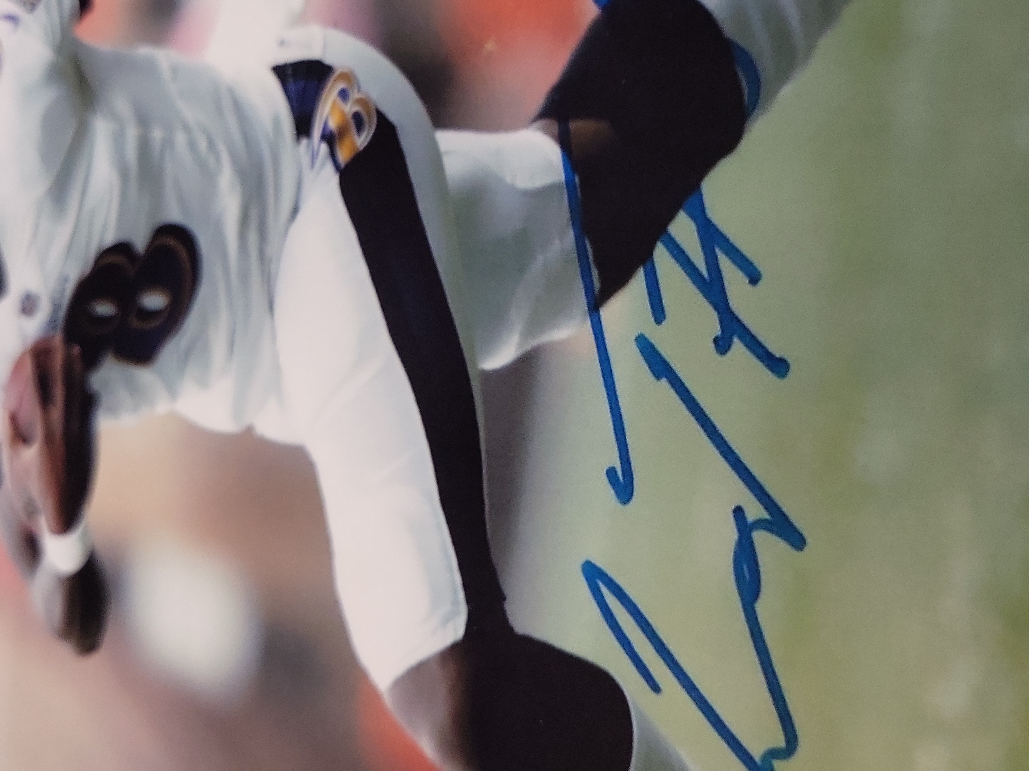 I03645 | A Collection of Baltimore Ravens Memorabilia Including Framed Joe Flacco Plaque and Autographed Lamar Jackson Photo